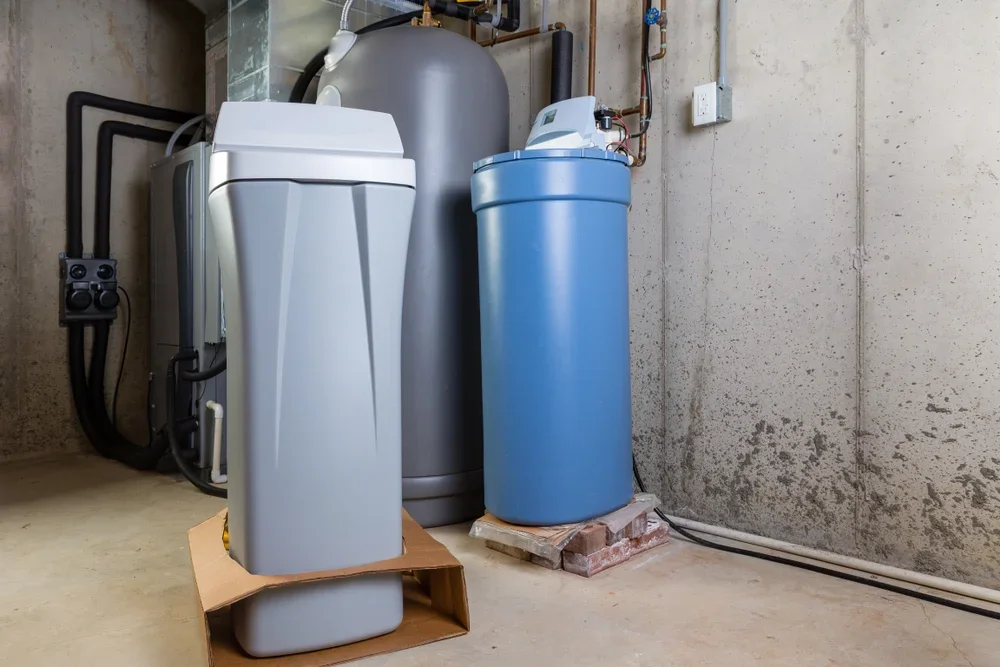 Water filtration equipment and water softener system in a utility room.