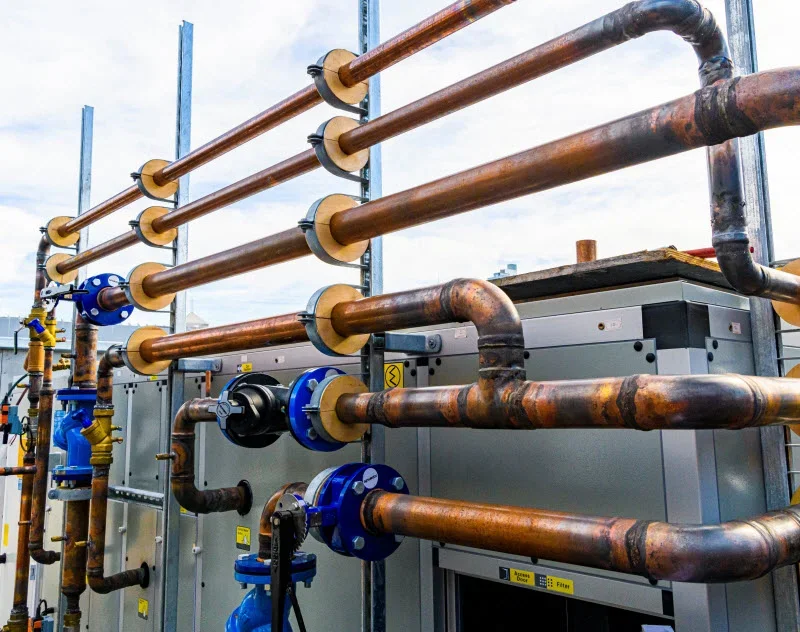 Industrial pipes and equipment on a rooftop or outdoor setting