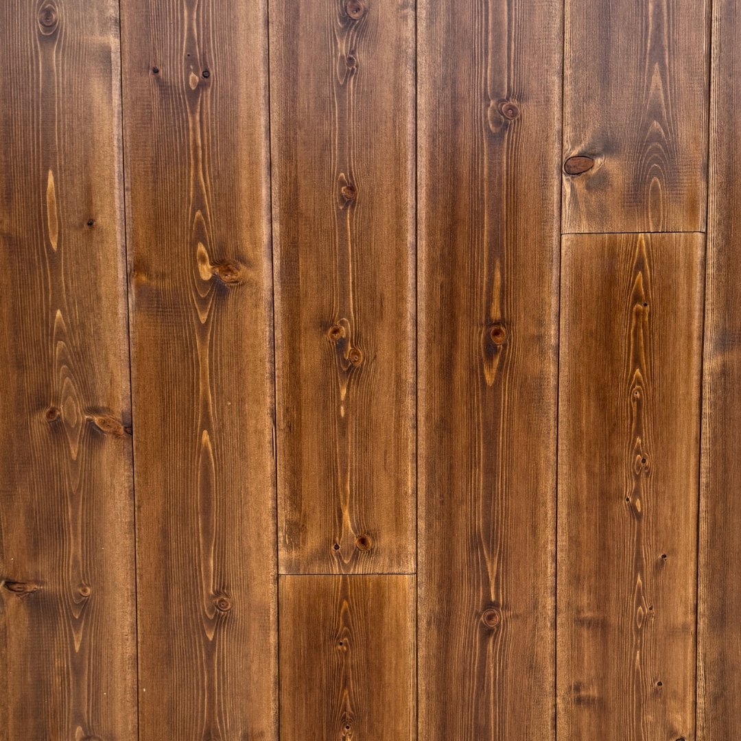Premier Plank Barrel Proof factory-finished European Pine paneling in deep rich brown with pronounced grain and knot detail.