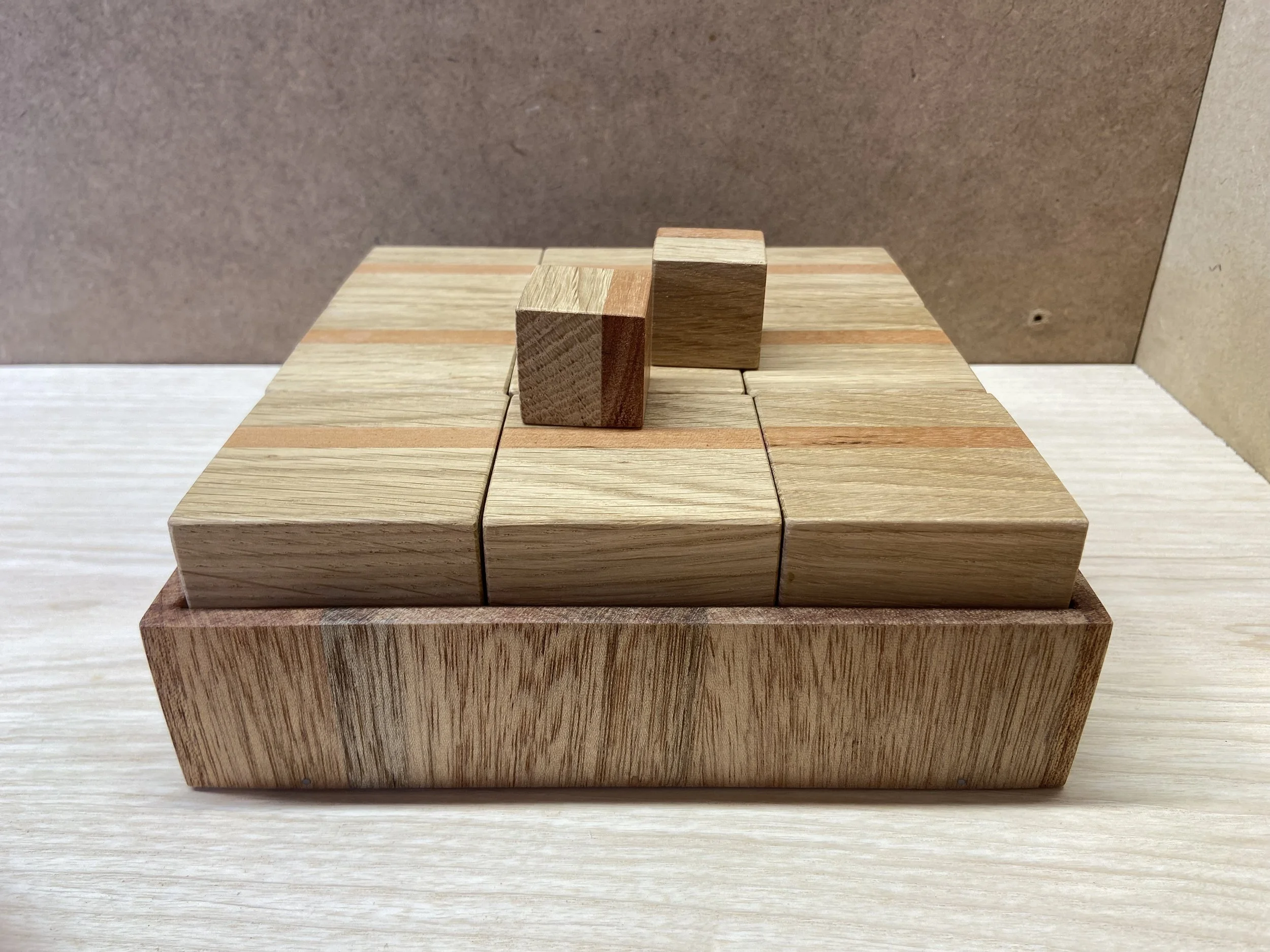Set of wooden blocks arranged on a wooden table with a brown and beige background.