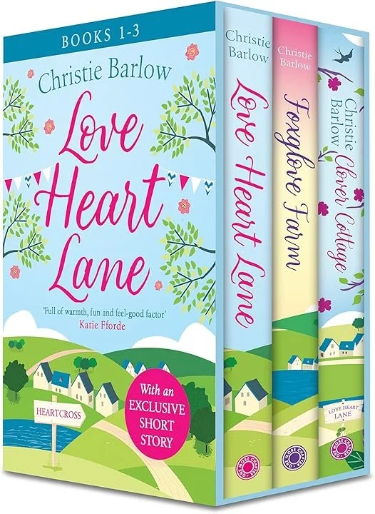 A three-book set of 'Love Heart Lane' series by Christie Barlow, featuring colourful covers with illustrations of a village, trees, and a lake, with titles and author names displayed prominently.