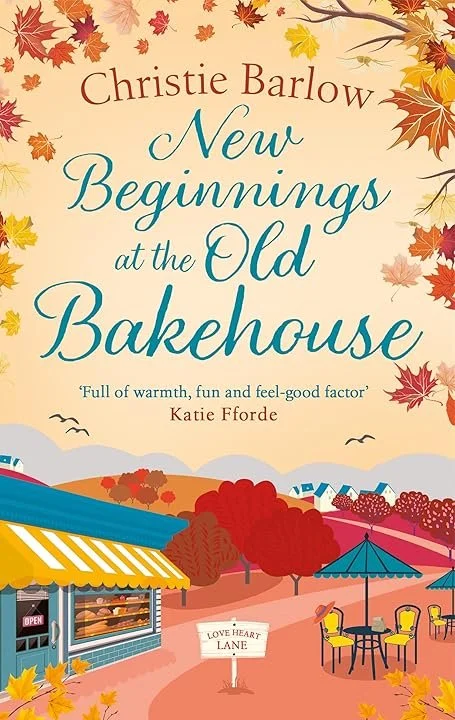 Book cover titled 'New Beginnings at the Old Bakehouse' by Christie Barlow with autumn leaves and a village scene with a bakery, outdoor seating, and colourful trees.