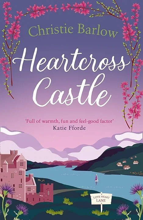 Book cover of 'Heartcross Castle' by Christie Barlow, featuring a scenic illustration of a castle by a lake, pink flowering branches, and mountains in the background.