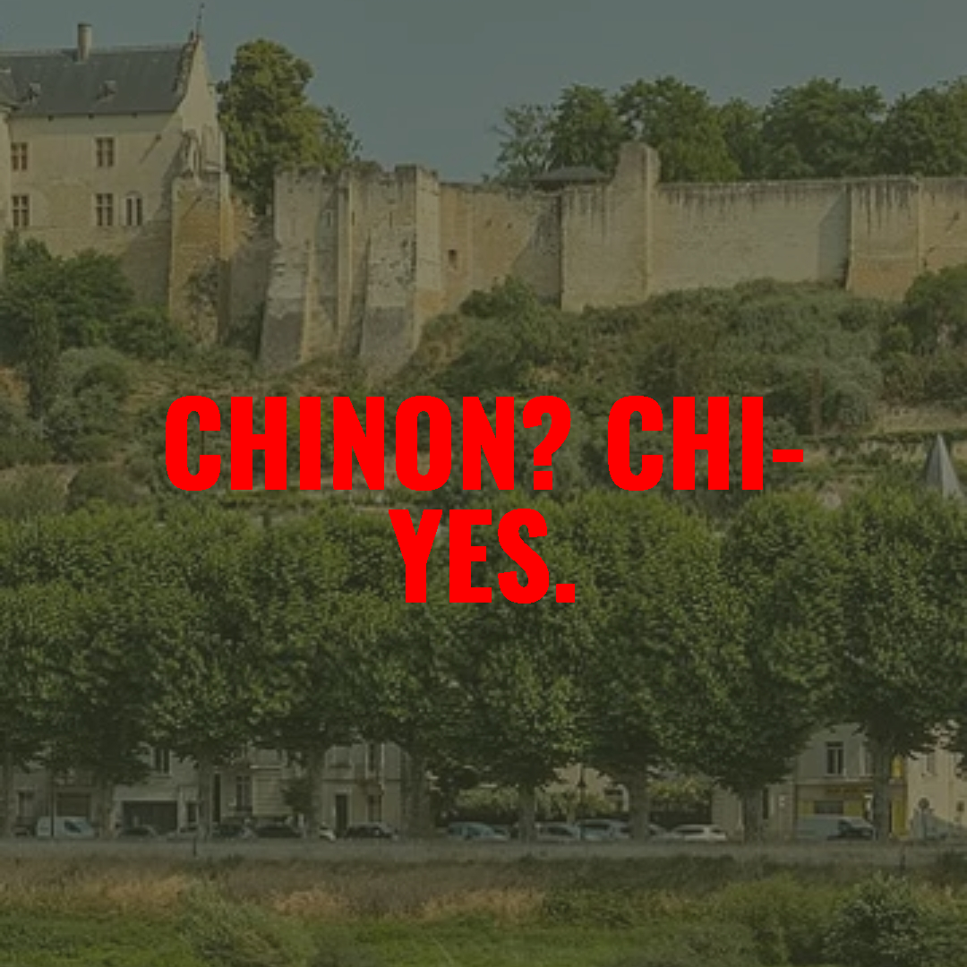A scenic view of an old castle or fortress on a hill with trees and buildings at the ground level. Overlaid with red text reading 'CHINON? CHI-YES.'