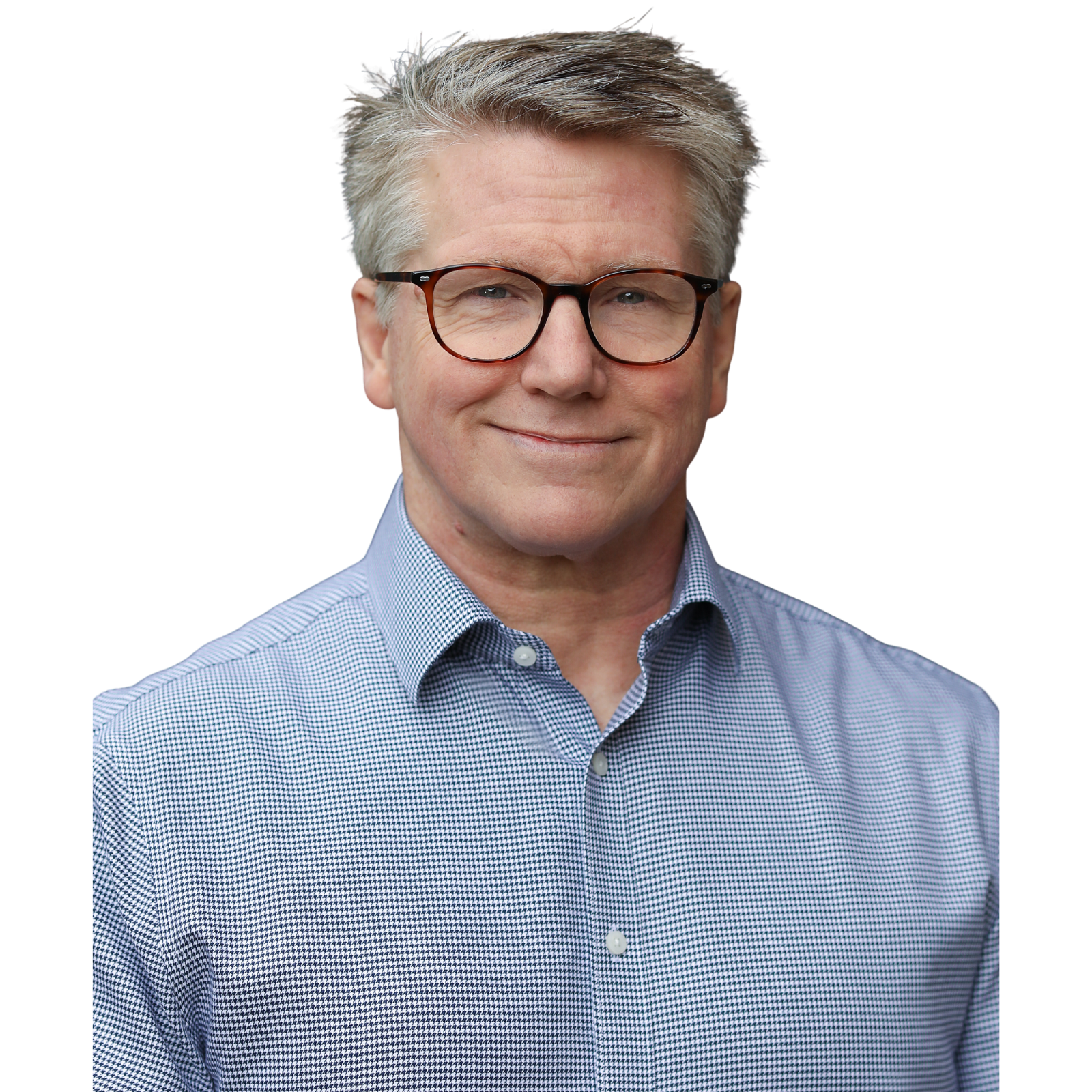 A middle-aged man with gray hair, wearing glasses, a blue checkered button-up shirt, and smiling.