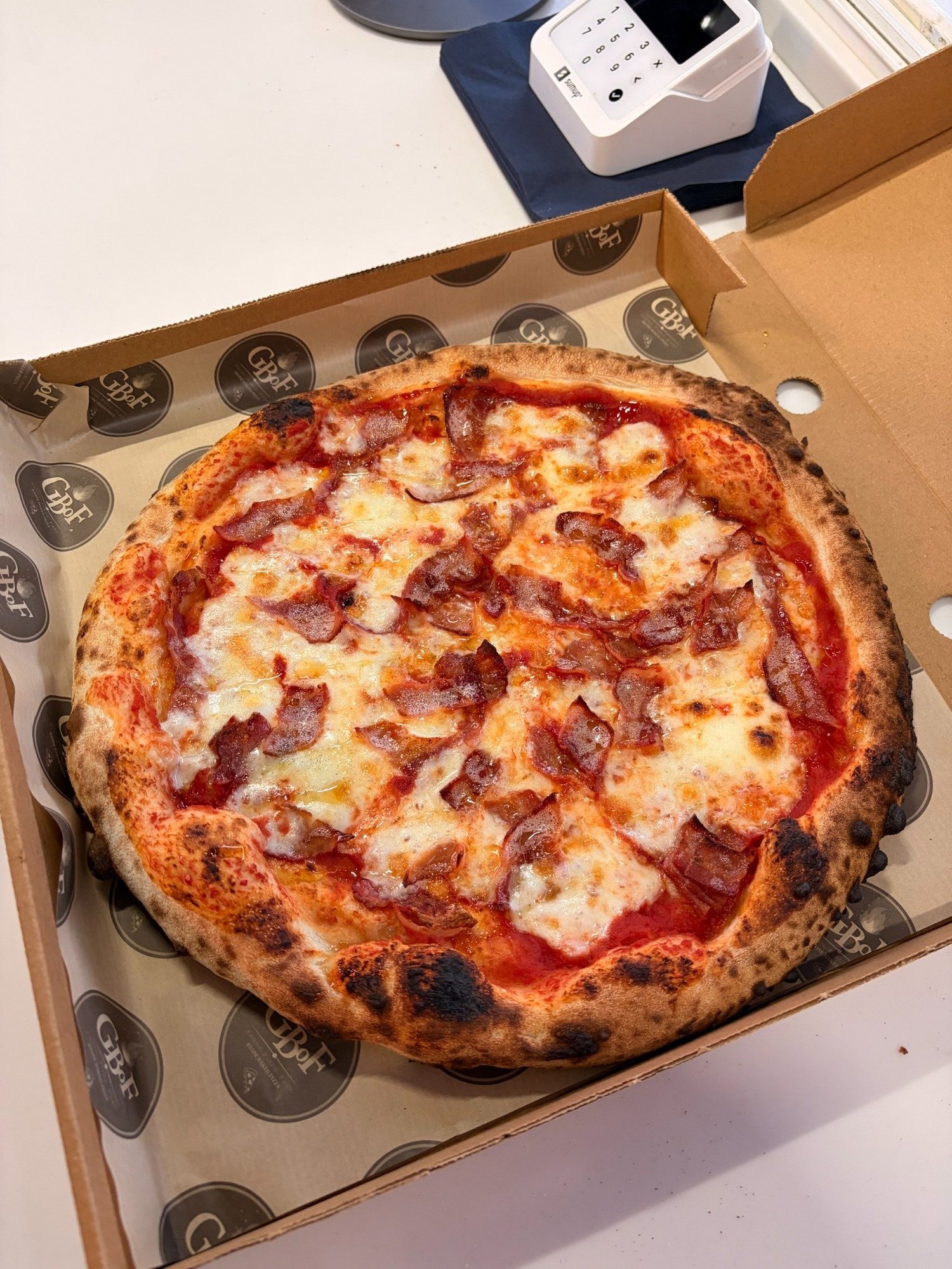 GBoF stone-baked bacon pizza in a branded takeaway box