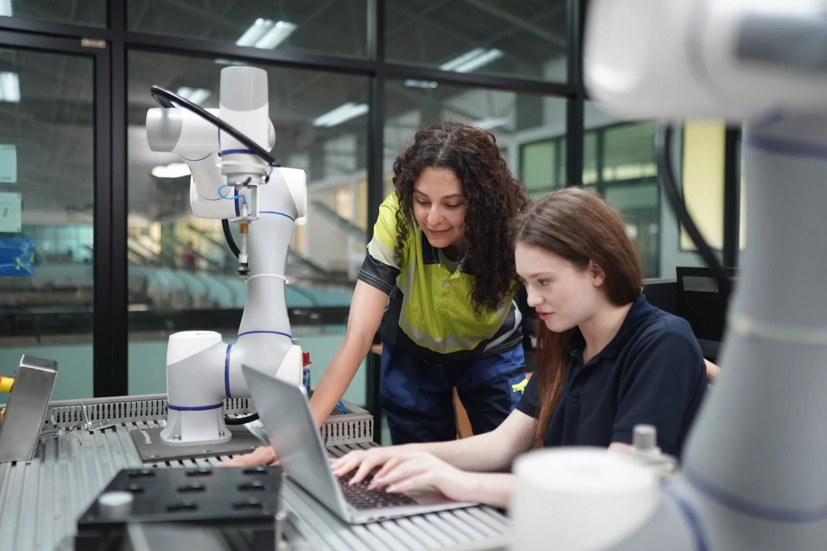 Two student working together on a laptop in a University lab.