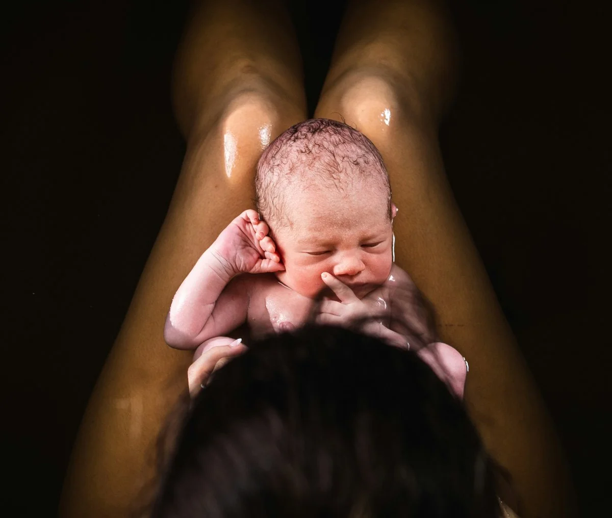 The serene moment after a natural home birth with the support of a doula.