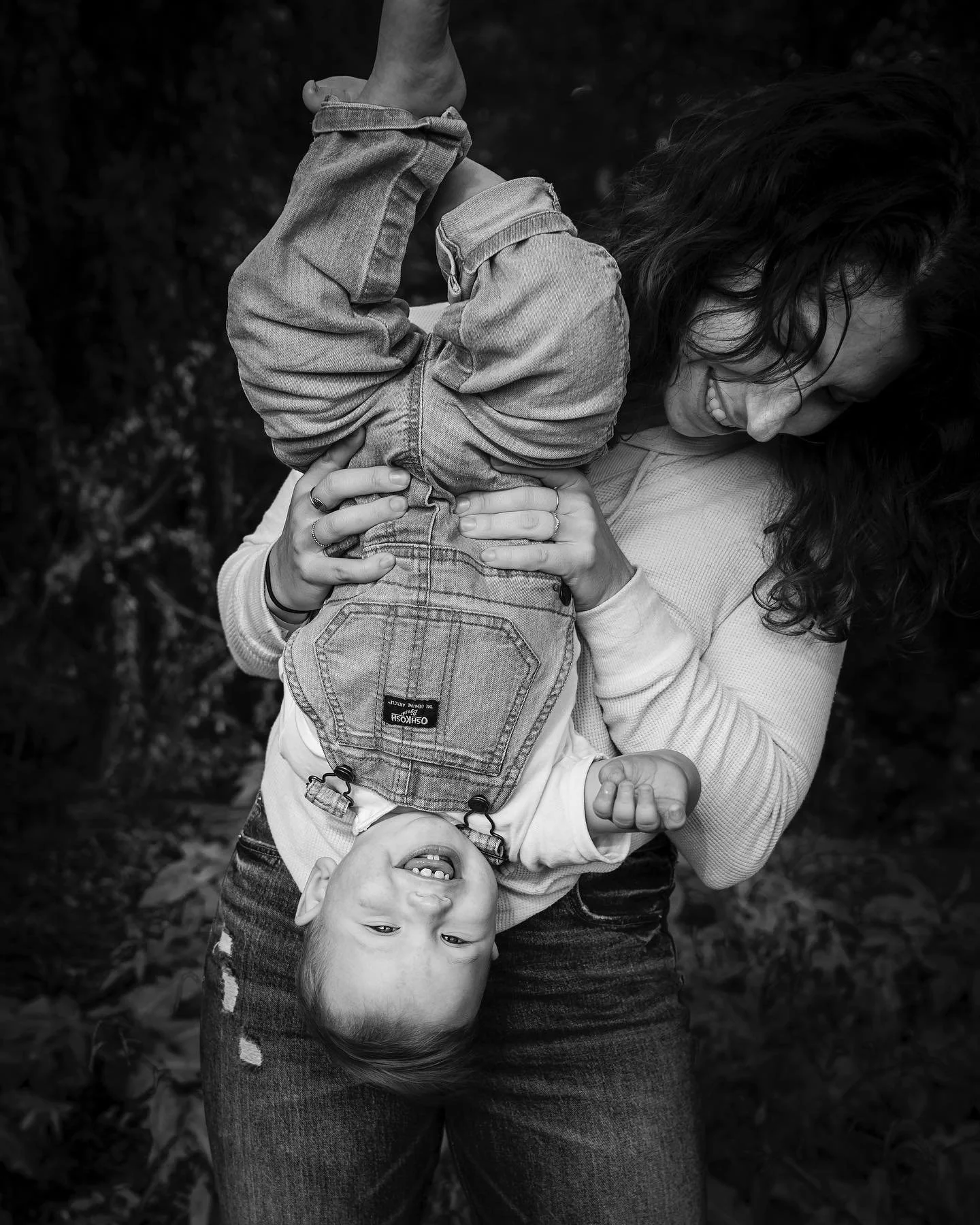 Hire a doula in Boston for birth support. Doula Courtney holding her son upside down and laughing.