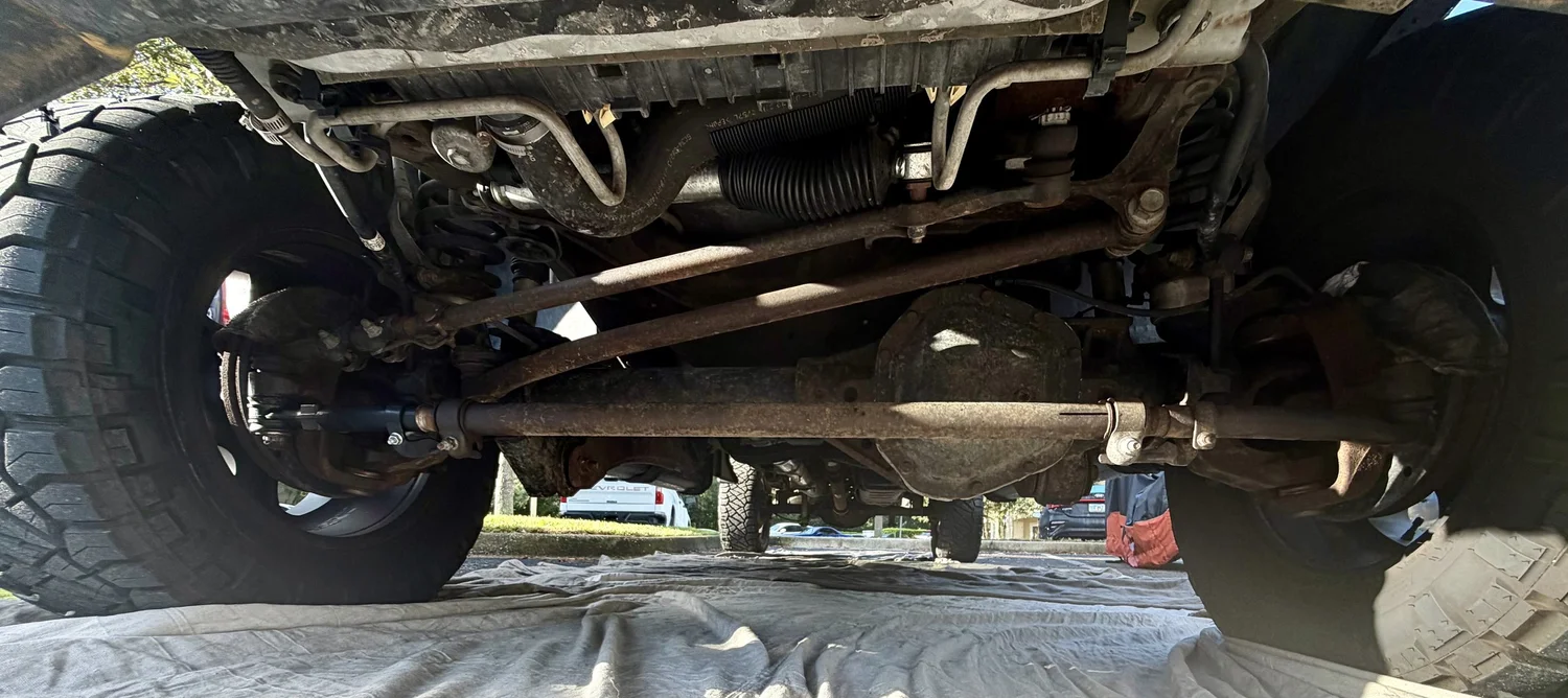 Rusted truck undercarriage before undercoating