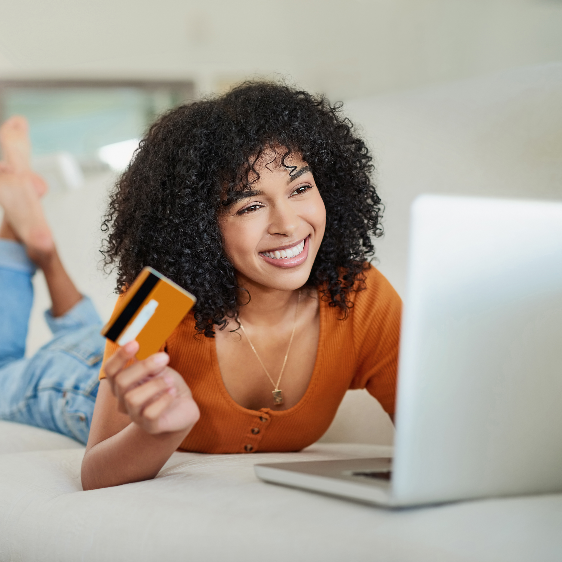 Homeowner getting an instant online painting quote with a credit card and laptop