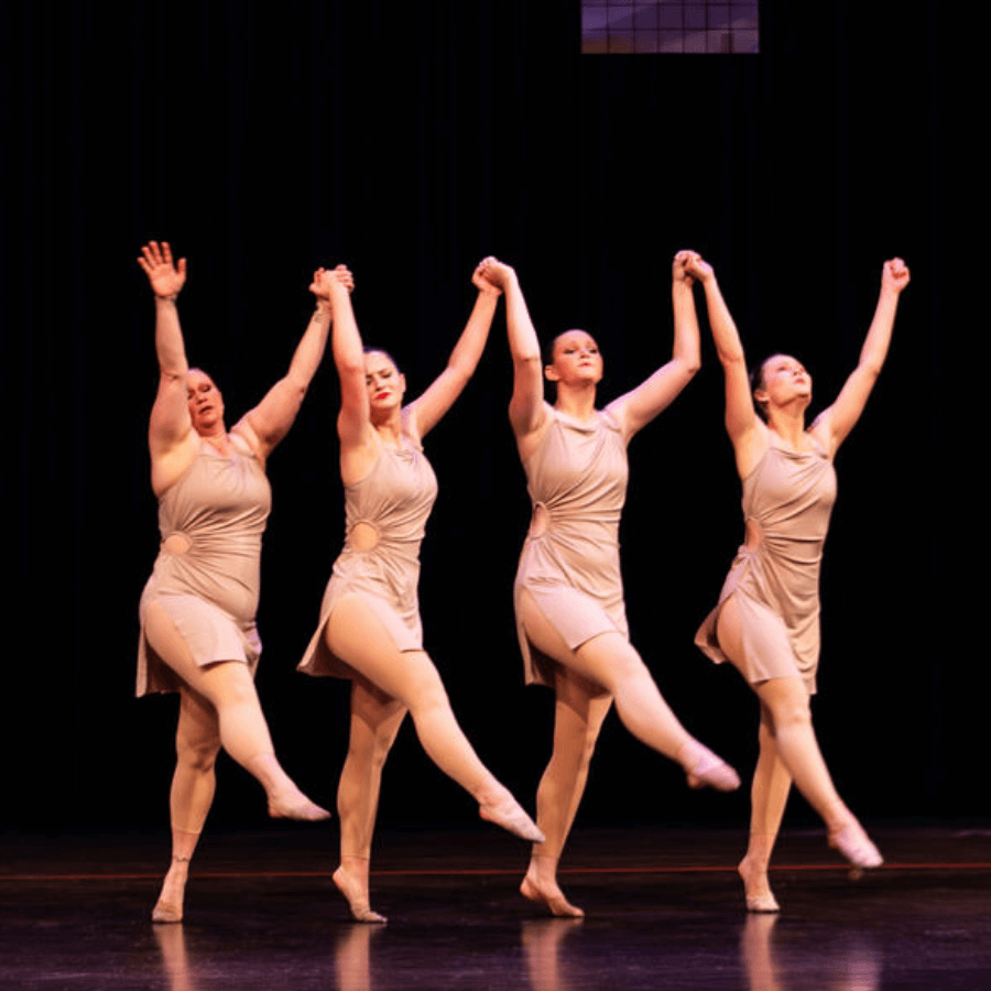 High school age dancers performing in gold costumes