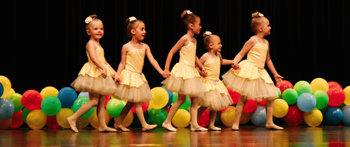 Ballet dance class holding hands on stage in performance