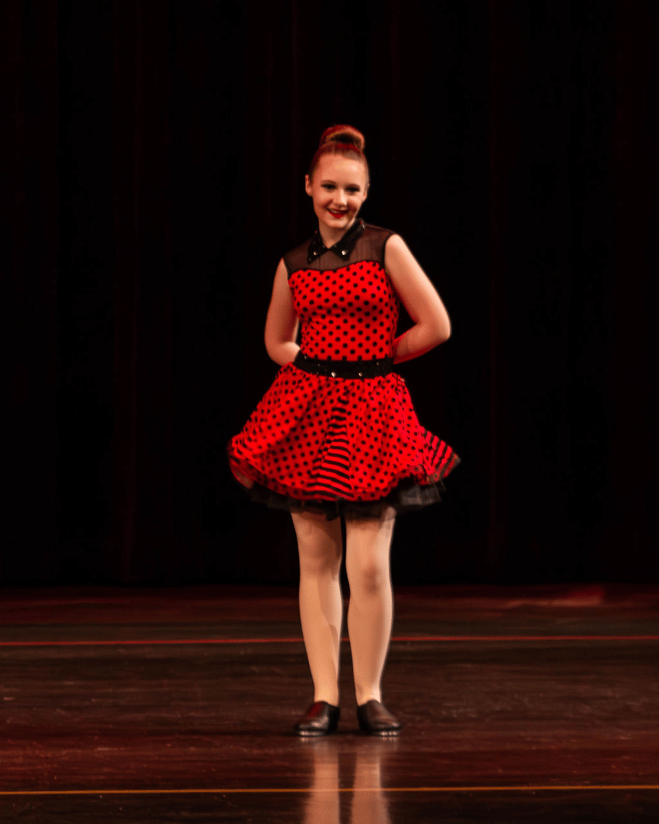Tap dancer in red costume performing in recital for Crazy Moves Dance Studio