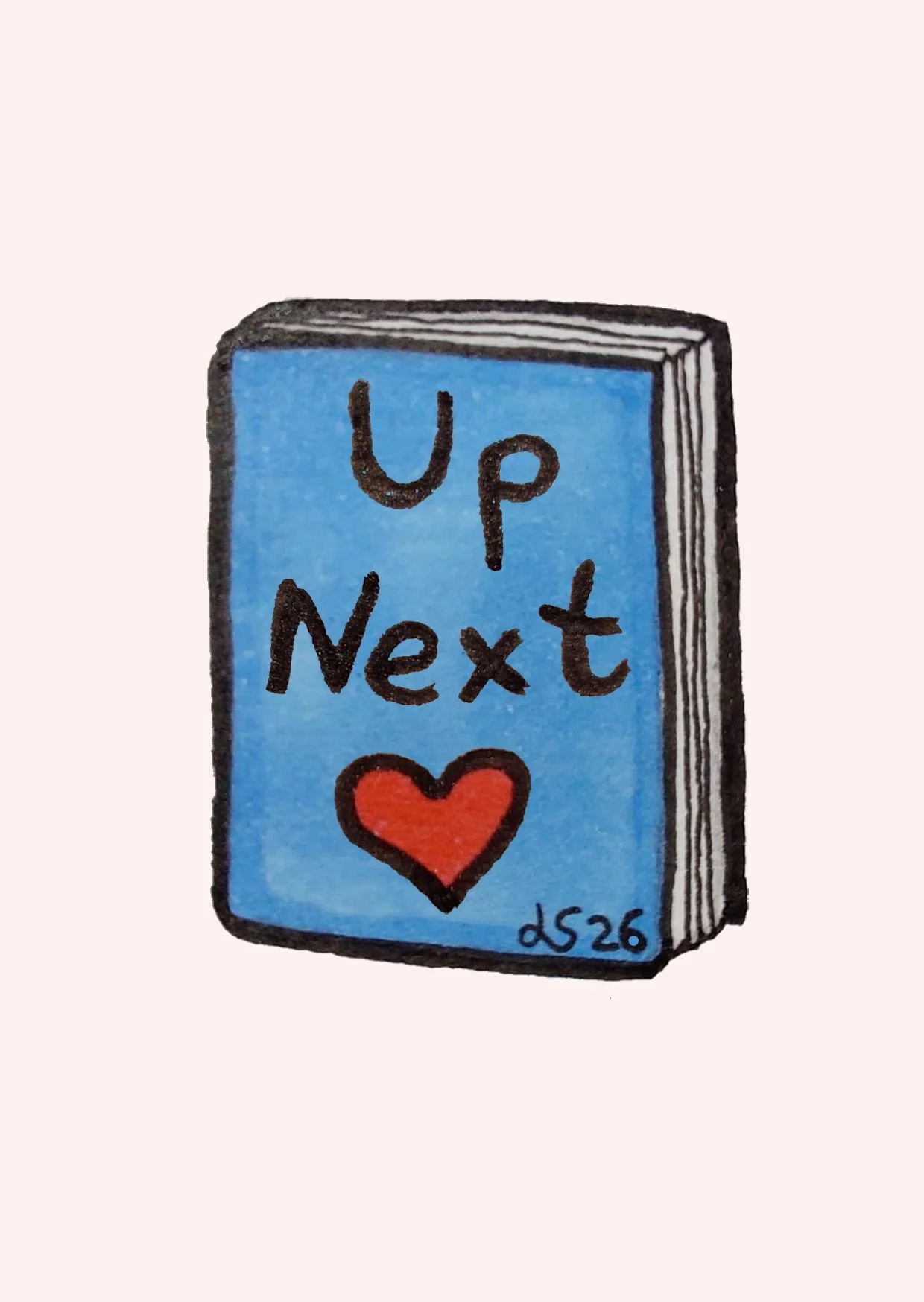 A blue book with the words "Up Next" and a red heart on the cover. The book has black outline details and the initials "LS26" at the bottom right.