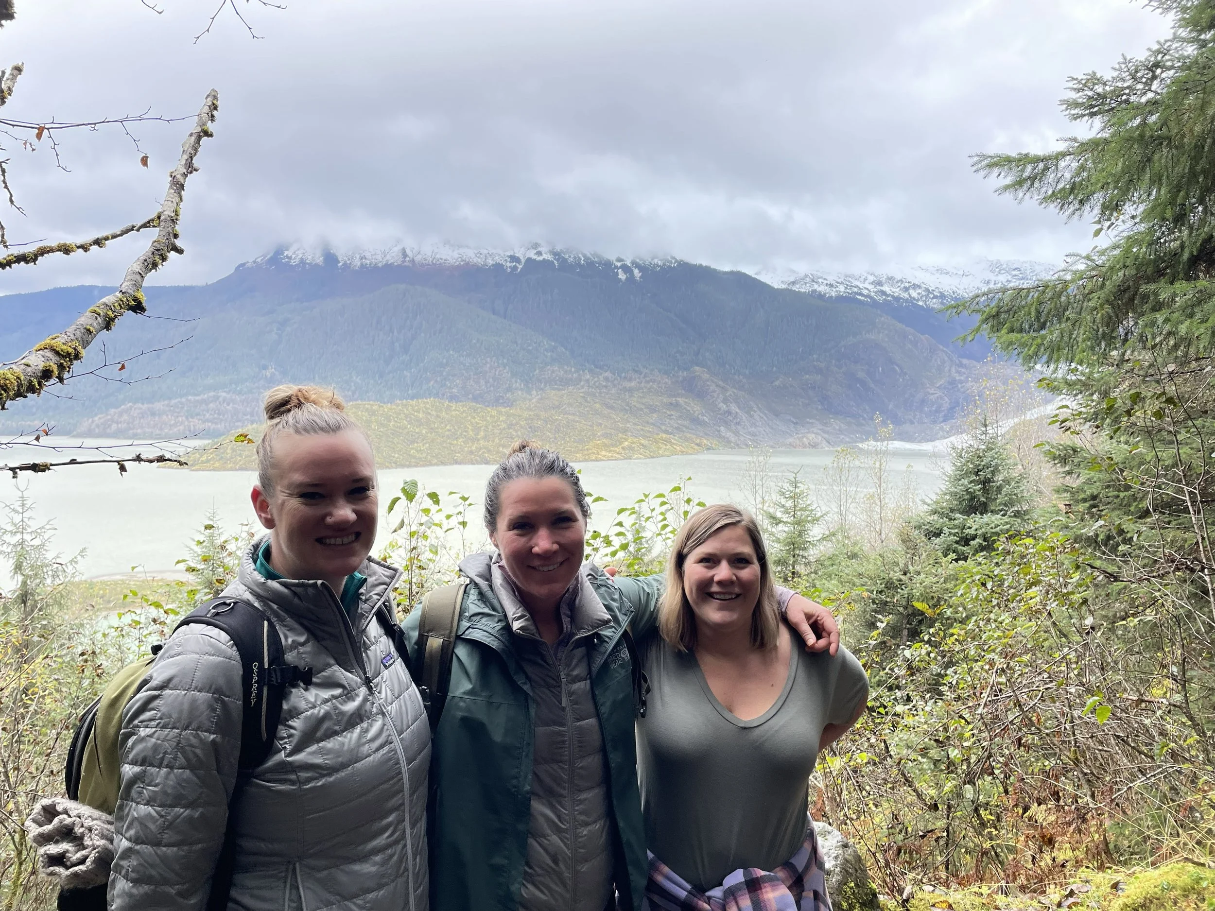 Friends hiking East Glacier trail near Mendenhall Glacier in Juneau AK.