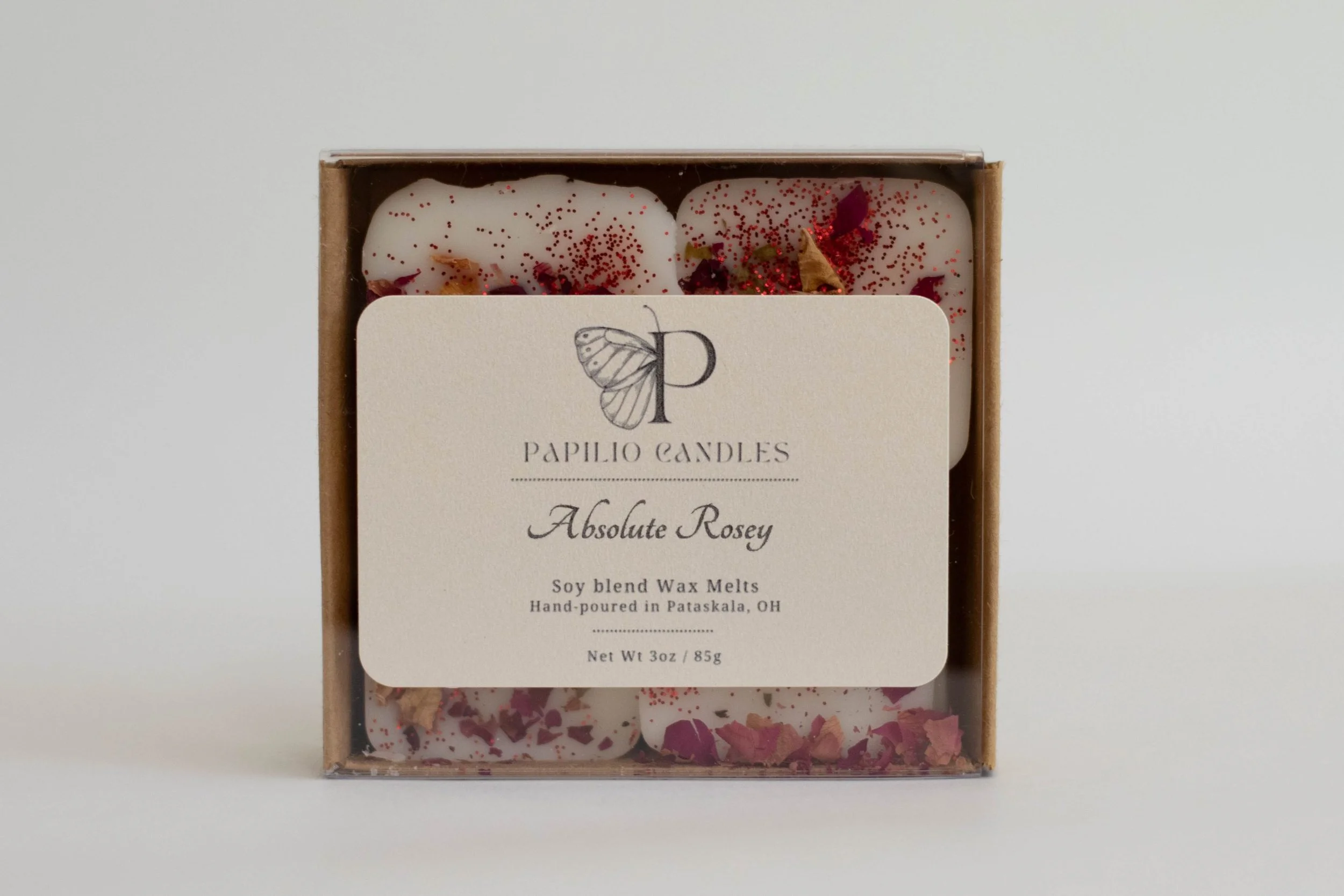 Box of soy blend wax melts labeled 'Absolute Rosey' with pink and red wax pieces and glitter on top.