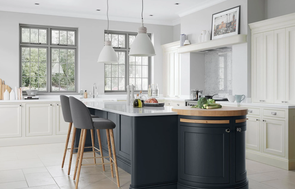 Bright kitchen with white cabinets, a navy blue island, pendant lights, and large windows allowing natural light.