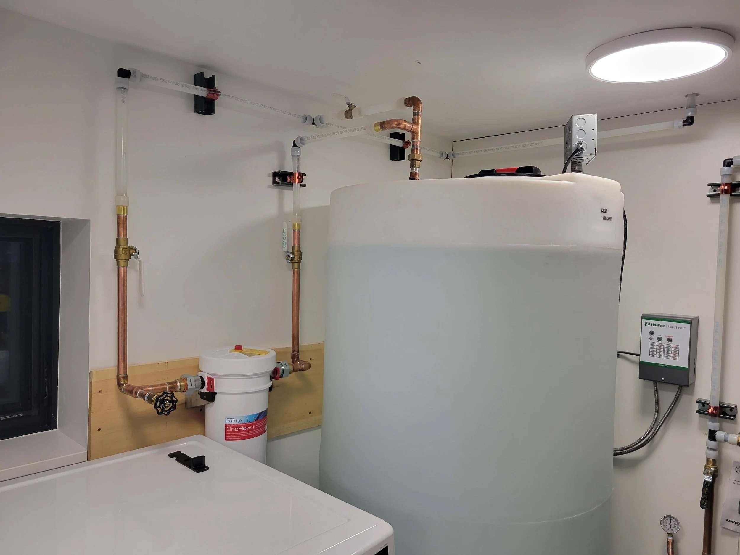 Room with water tank, copper pipes, filtration system, control panel