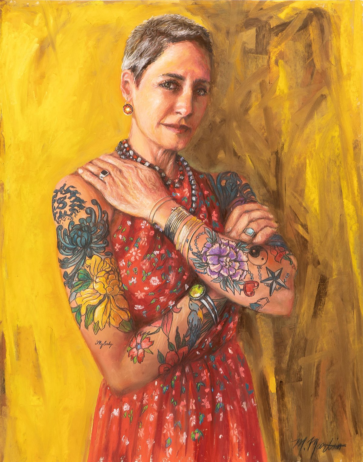 A portrait of a woman with short gray hair and tattoos on her arms, wearing a red dress with floral patterns, jewelry including rings, bracelets, necklaces, and earrings, set against a yellow background.