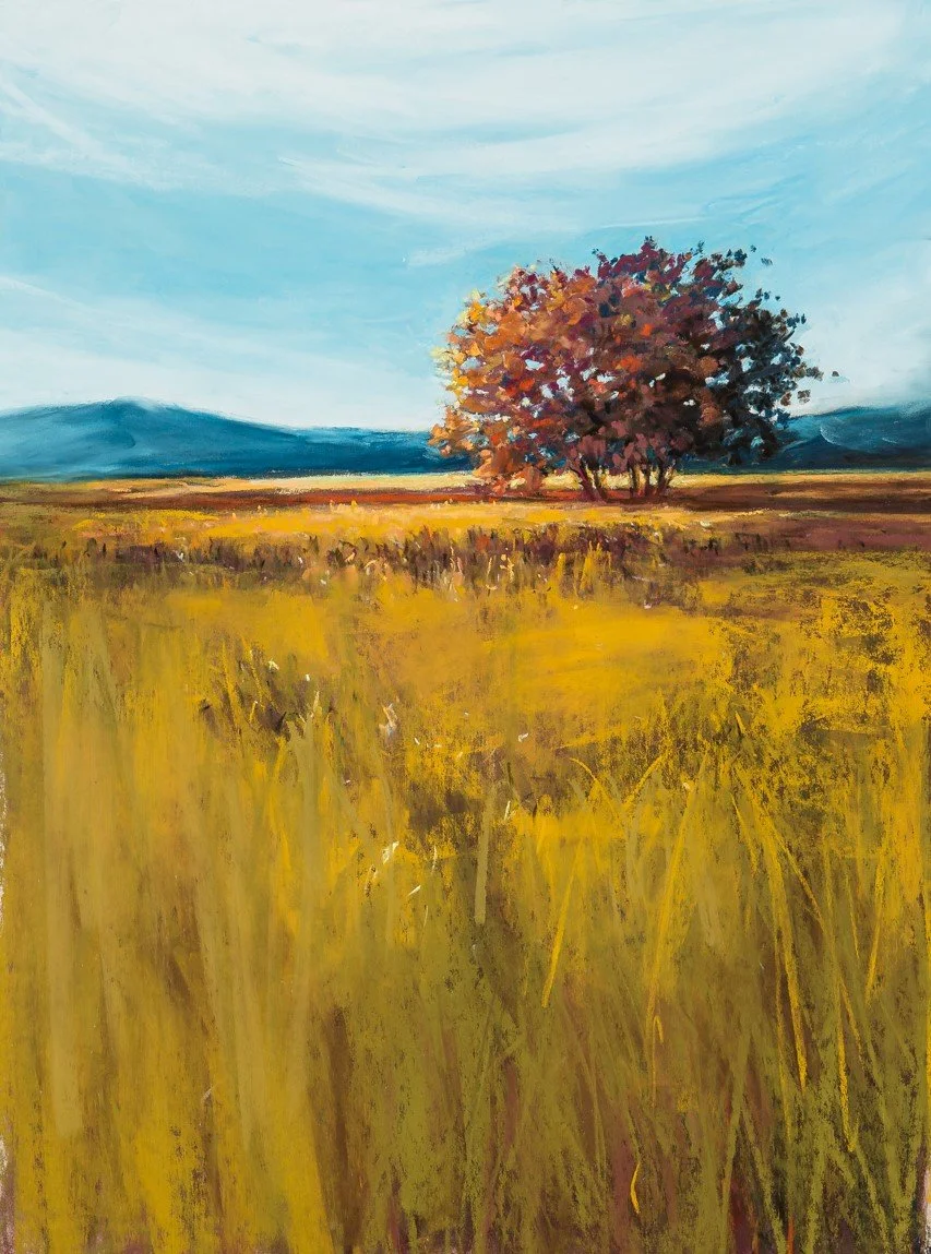 A painting of a large, colorful tree in a grassy field with mountains and a blue sky in the background.