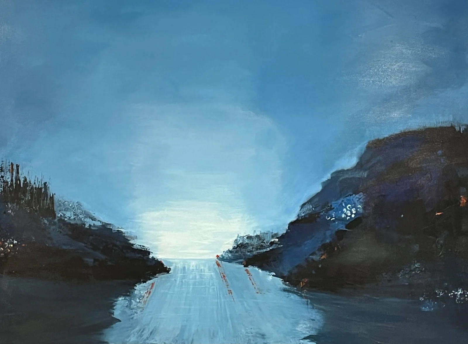 A painting of a landscape featuring a calm body of water between dark rocky hills under a bright blue sky with some clouds.