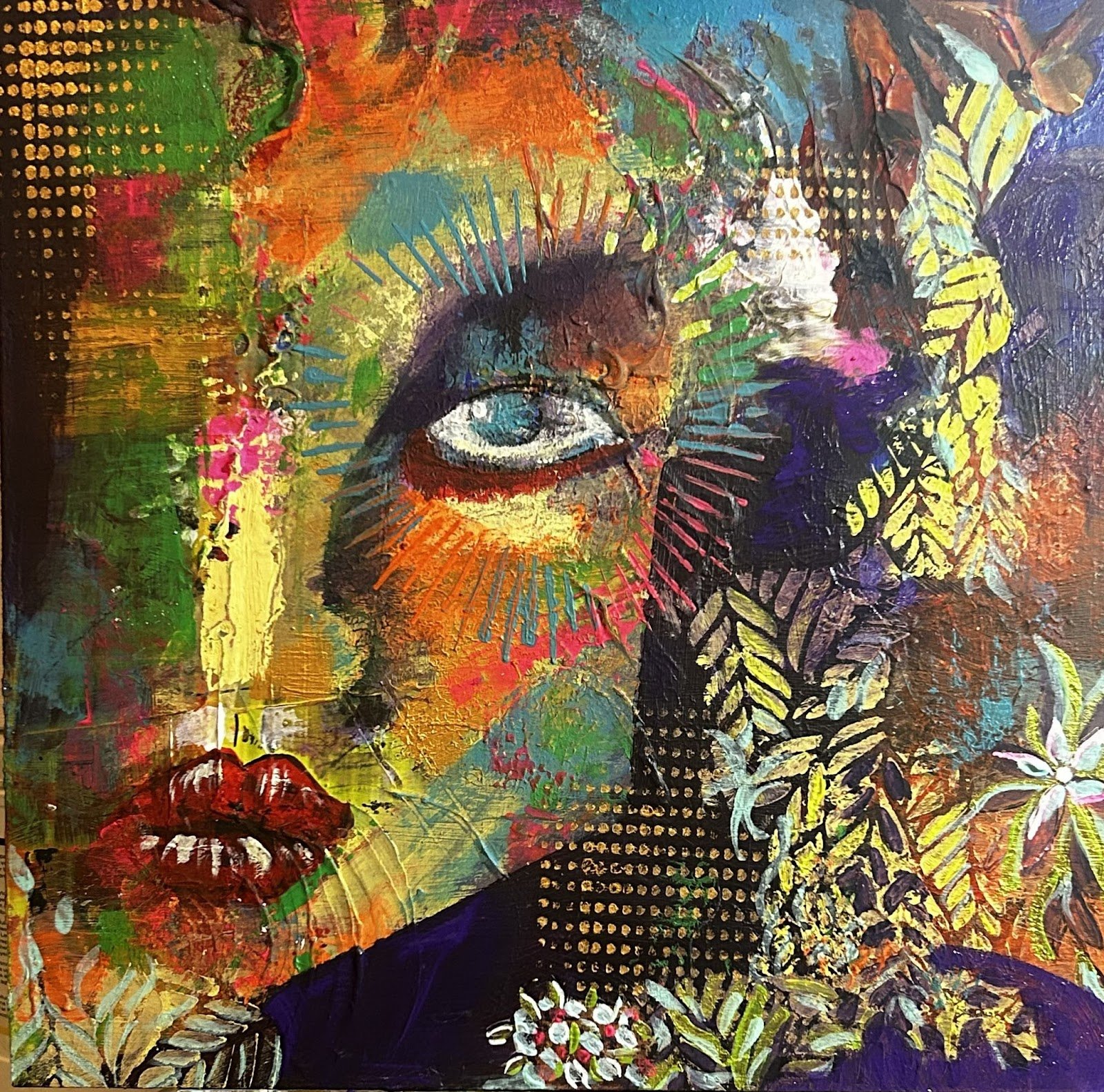 A colorful abstract painting featuring a woman's face with eyes closed, surrounded by vibrant strokes, patterns, and floral elements, with lips at the bottom.