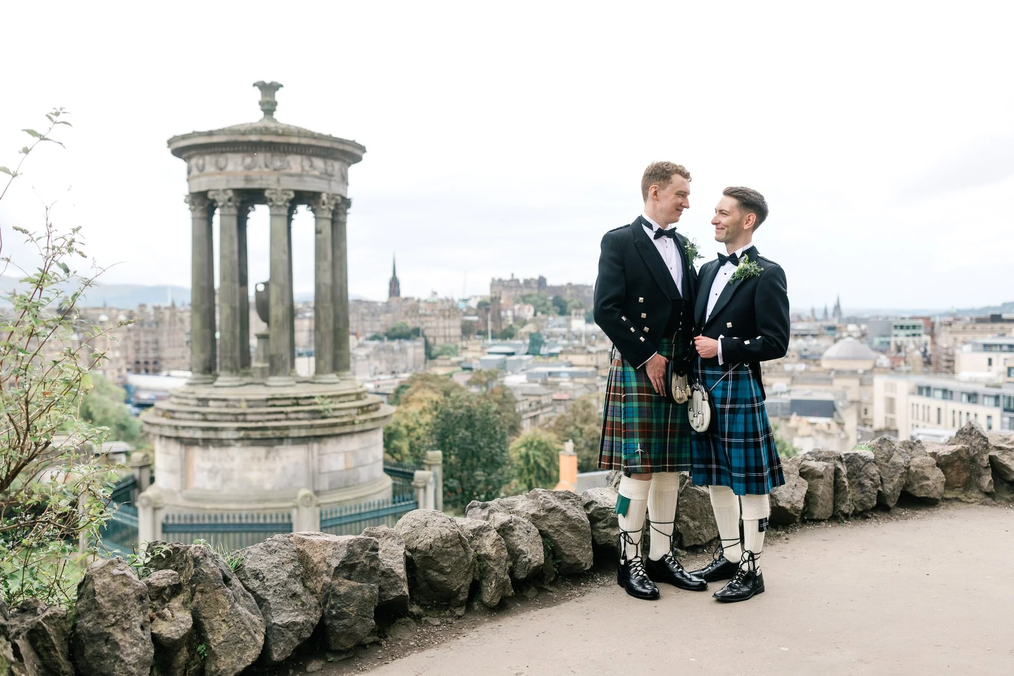Wedding couple overlooking Edinburgh beside the Dugald Stewart Monument