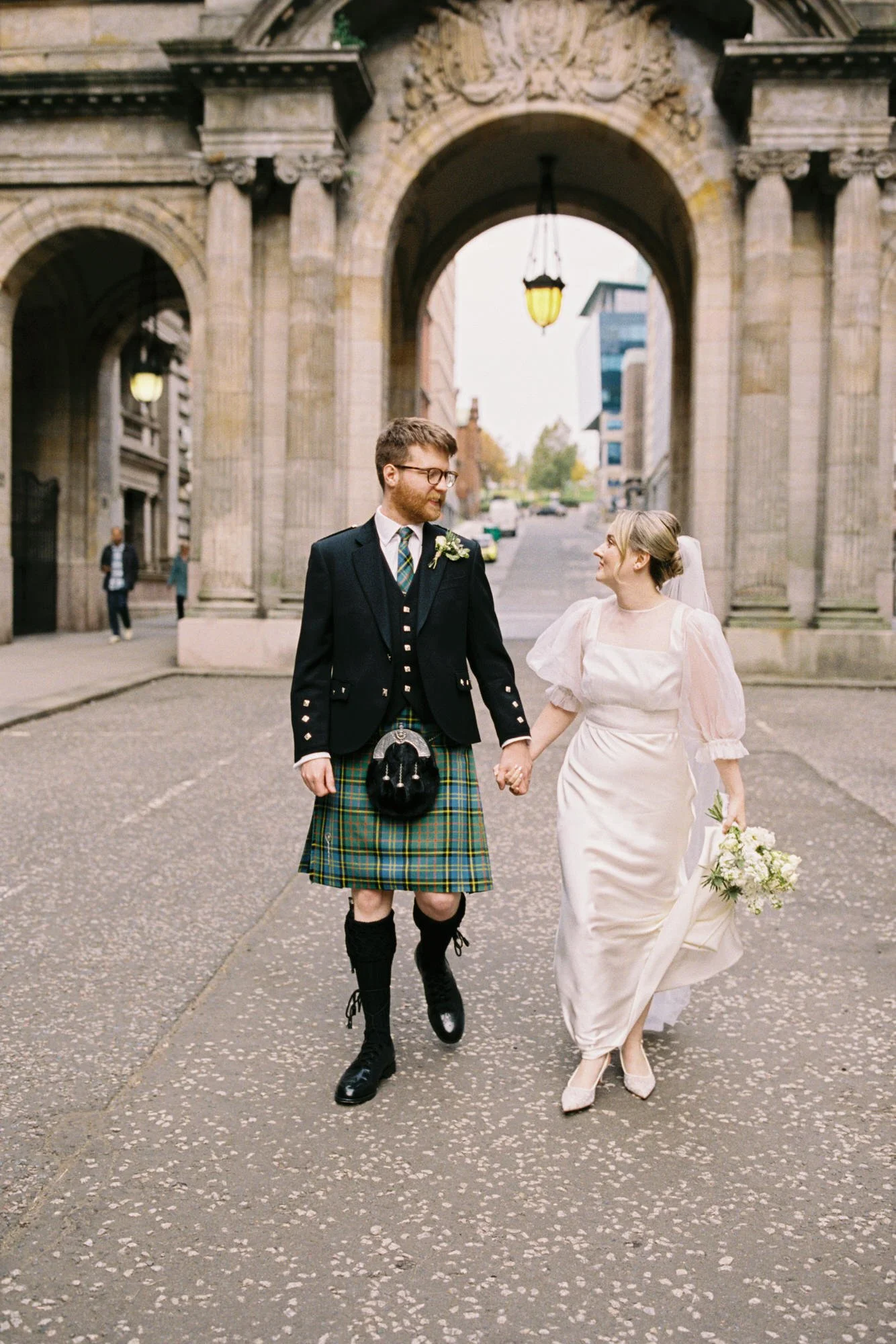 Erin and Matthew walking together after their Glasgow City Chambers wedding