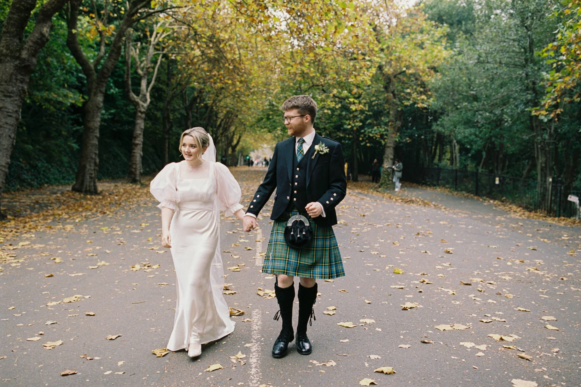 Erin and Matthew walking together after their Glasgow City Chambers wedding