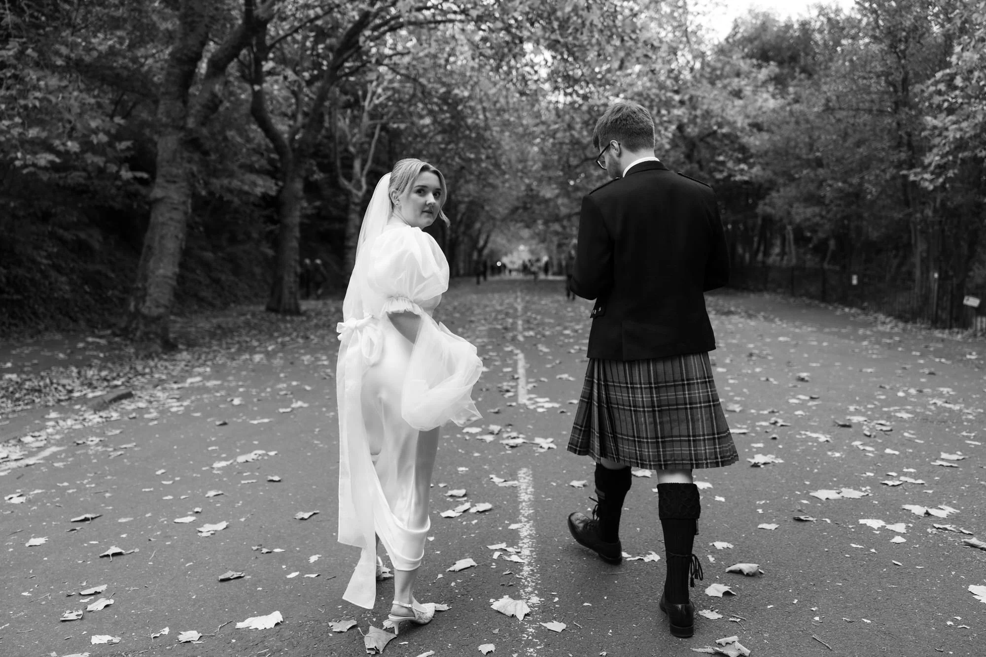 Relaxed newlywed portrait beside the autumn trees on Kelvin Way