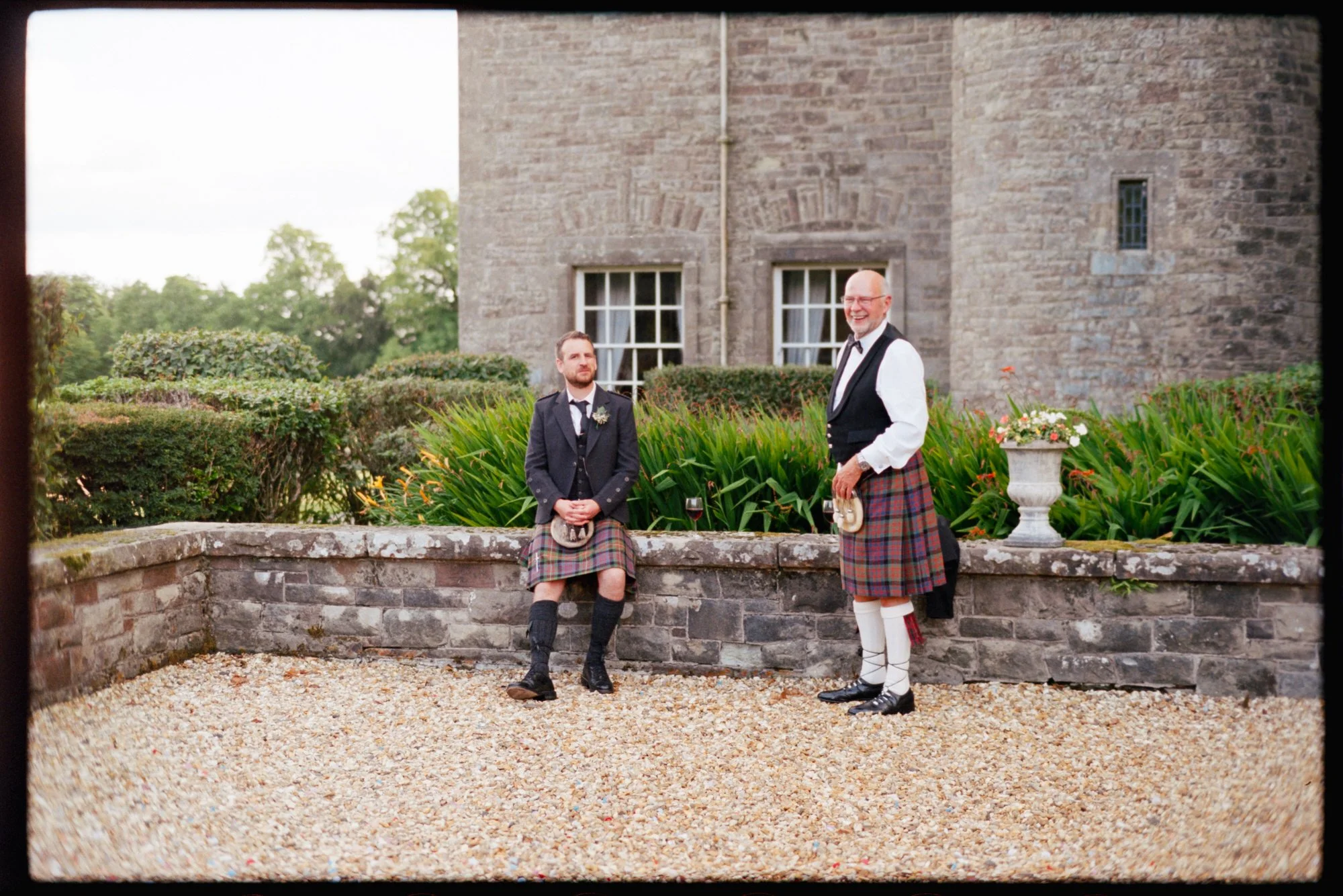 Newlyweds walking beside the old walls of Rowallan Castle