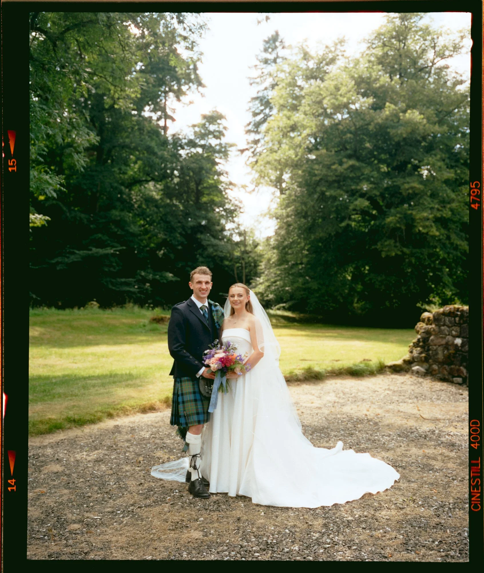 A candid newlywed moment in the castle grounds