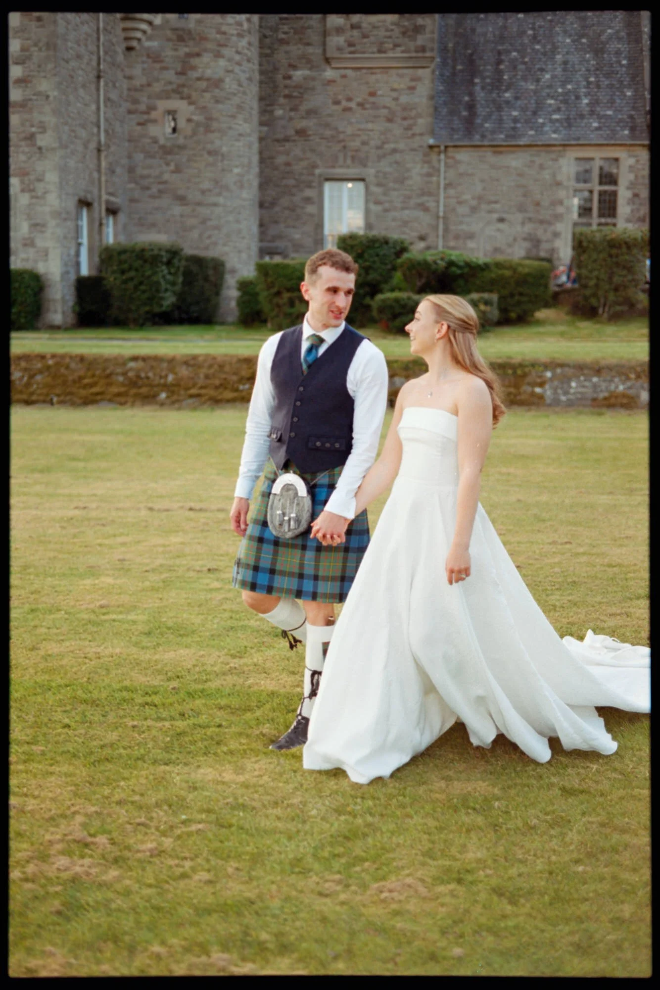 Iona and Lewis celebrating at their Rowallan Castle wedding