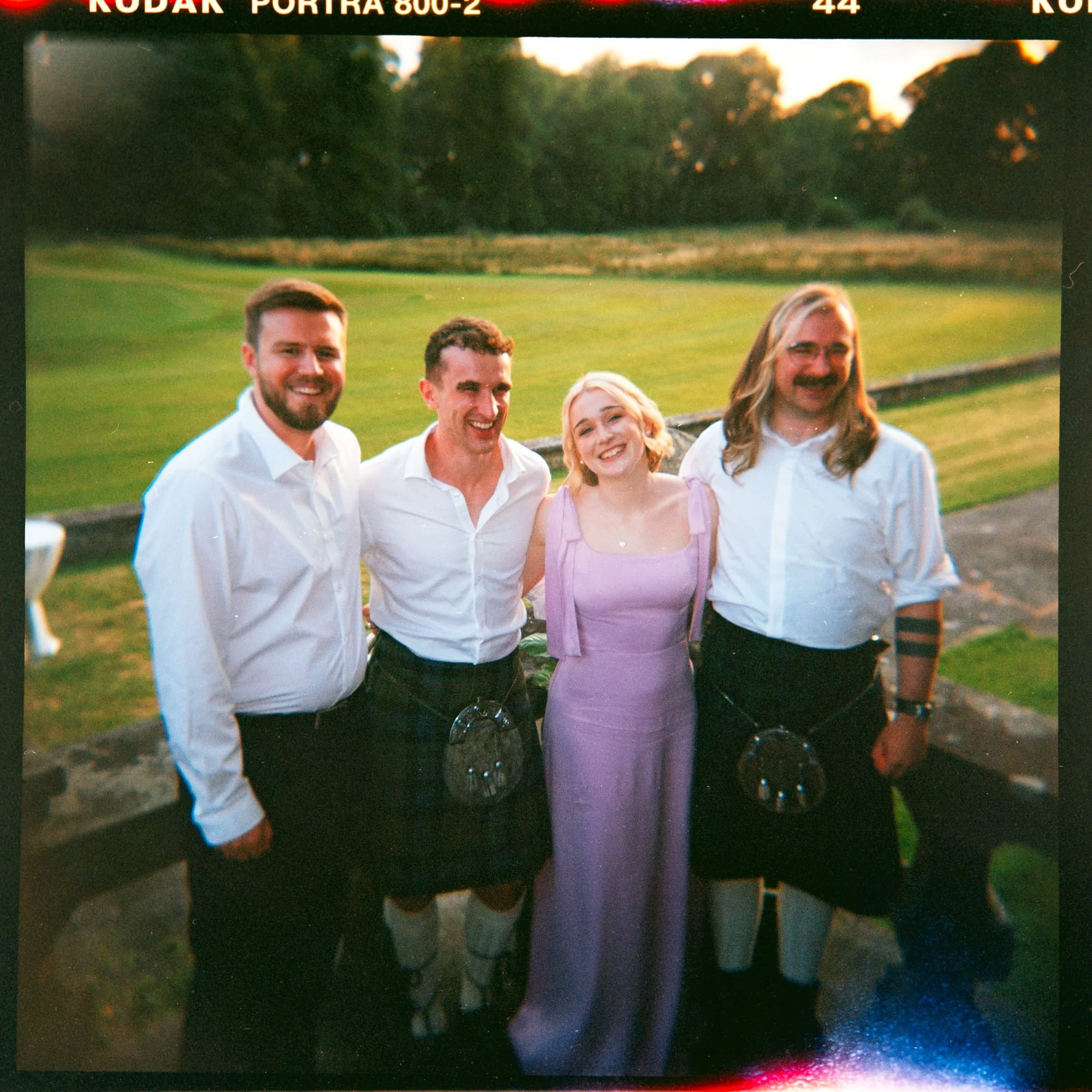 Iona and Lewis celebrating at their Rowallan Castle wedding
