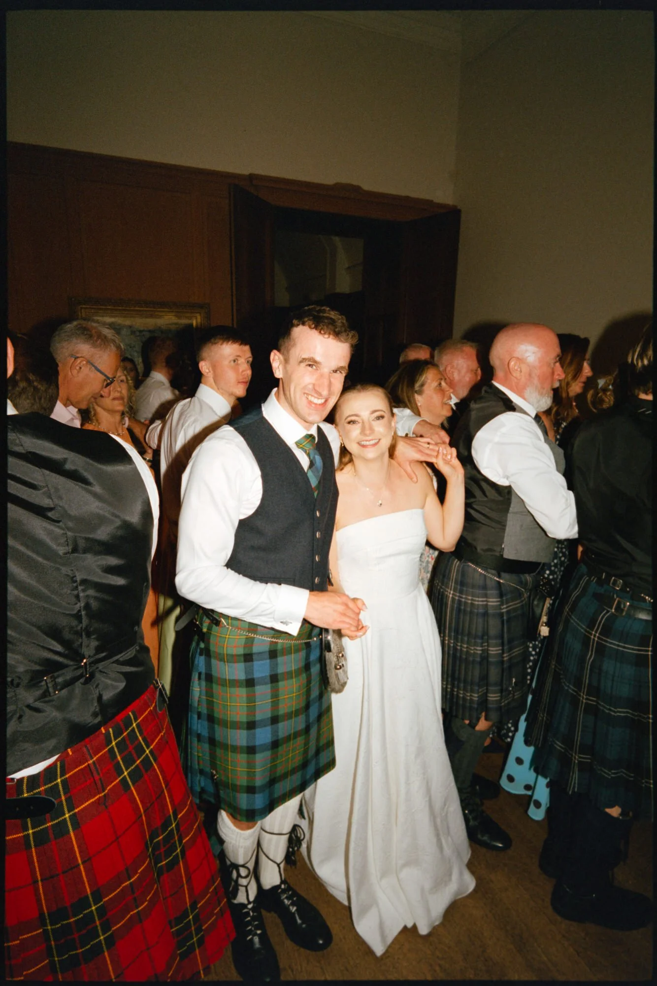 Iona and Lewis celebrating at their Rowallan Castle wedding