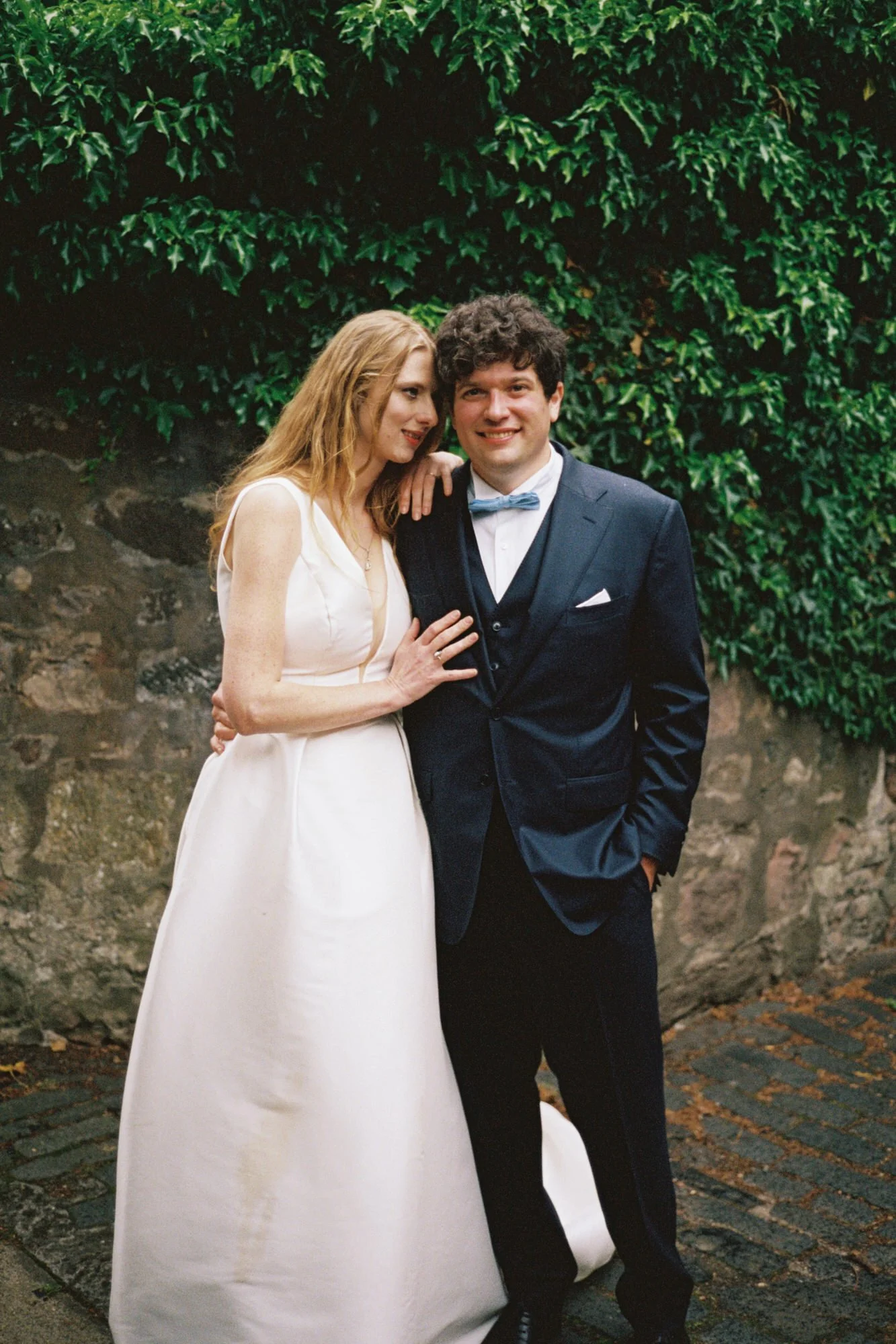 Newlywed couple walking through Edinburgh after their garden ceremony