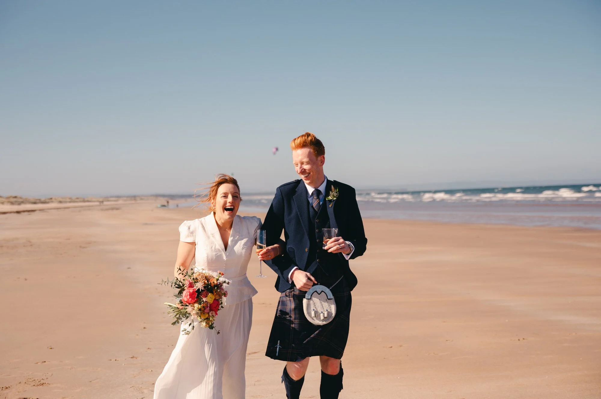 Hazel and Ally walking through St Andrews after their wedding ceremony