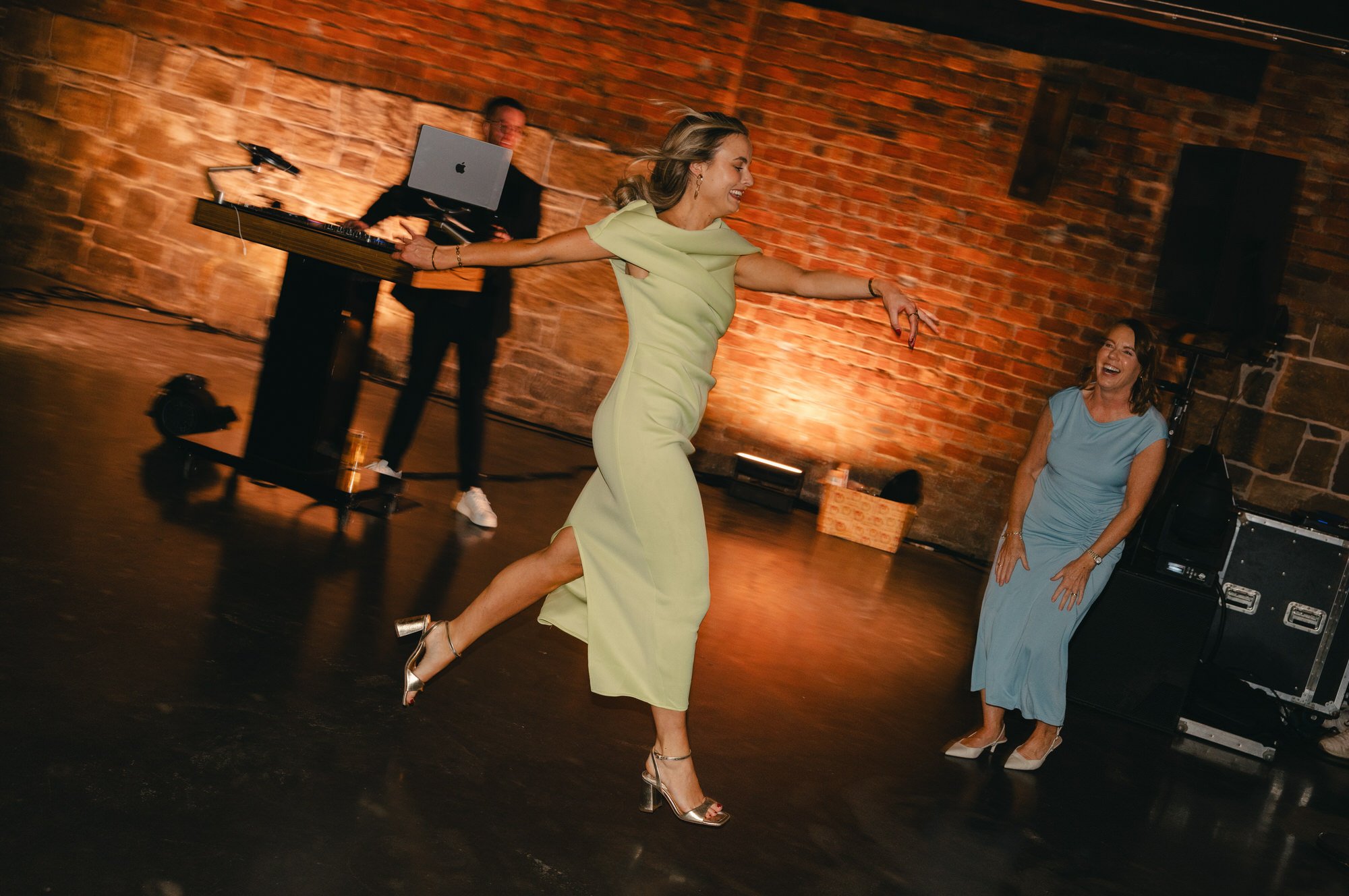 Hazel and Ally celebrating with friends beneath the lights at The Engine Works