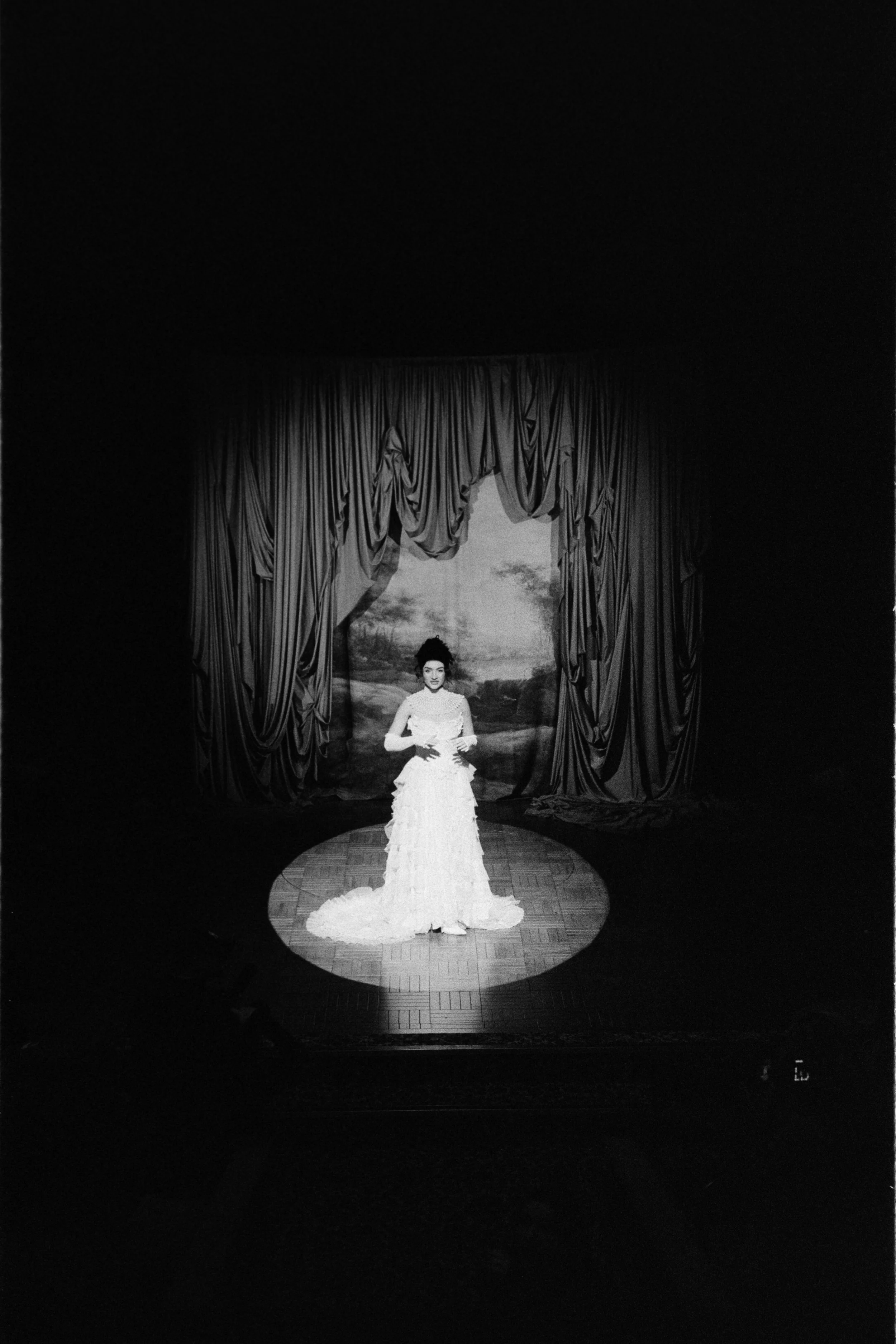Stage performer standing alone in a spotlight at the Royal Lyceum Theatre