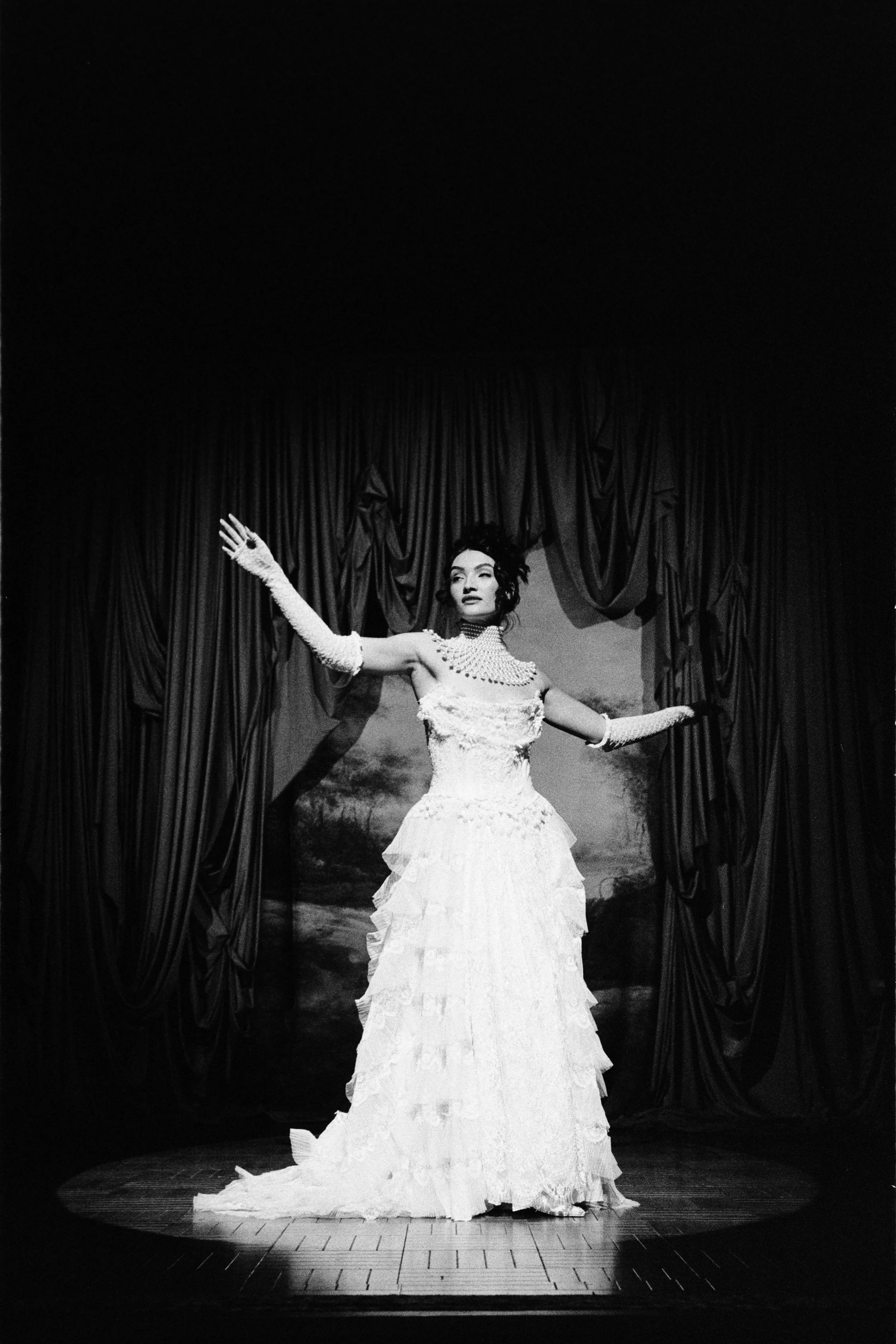 Performer in a white gown on stage photographed with a Leica M6