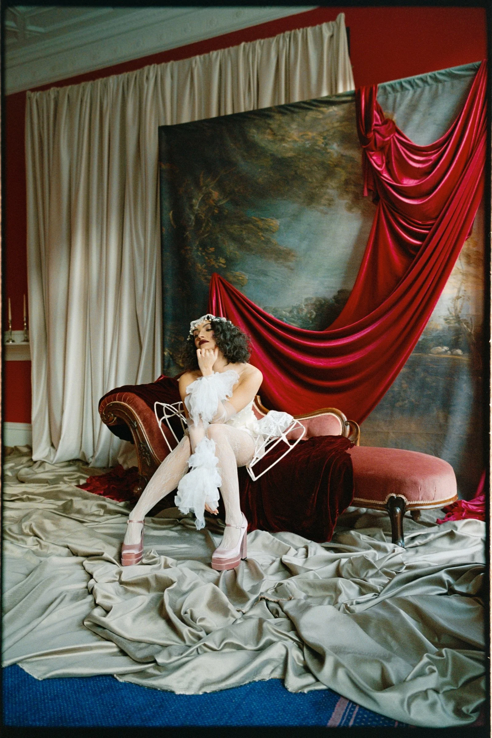 Male performer standing on a chair in a theatrical portrait setup