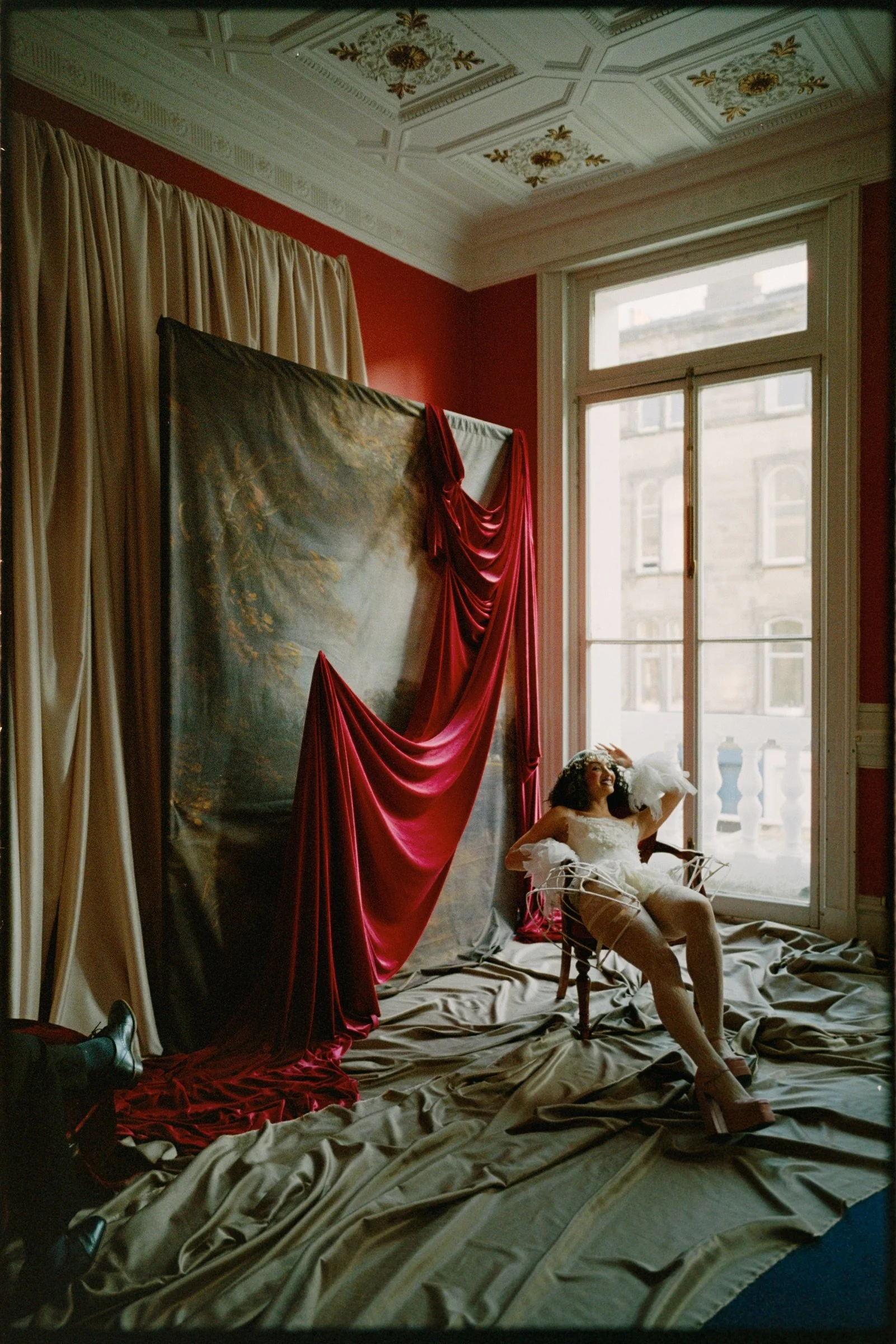 Warm Portra 800 portrait of a performer seated in the opera-inspired set