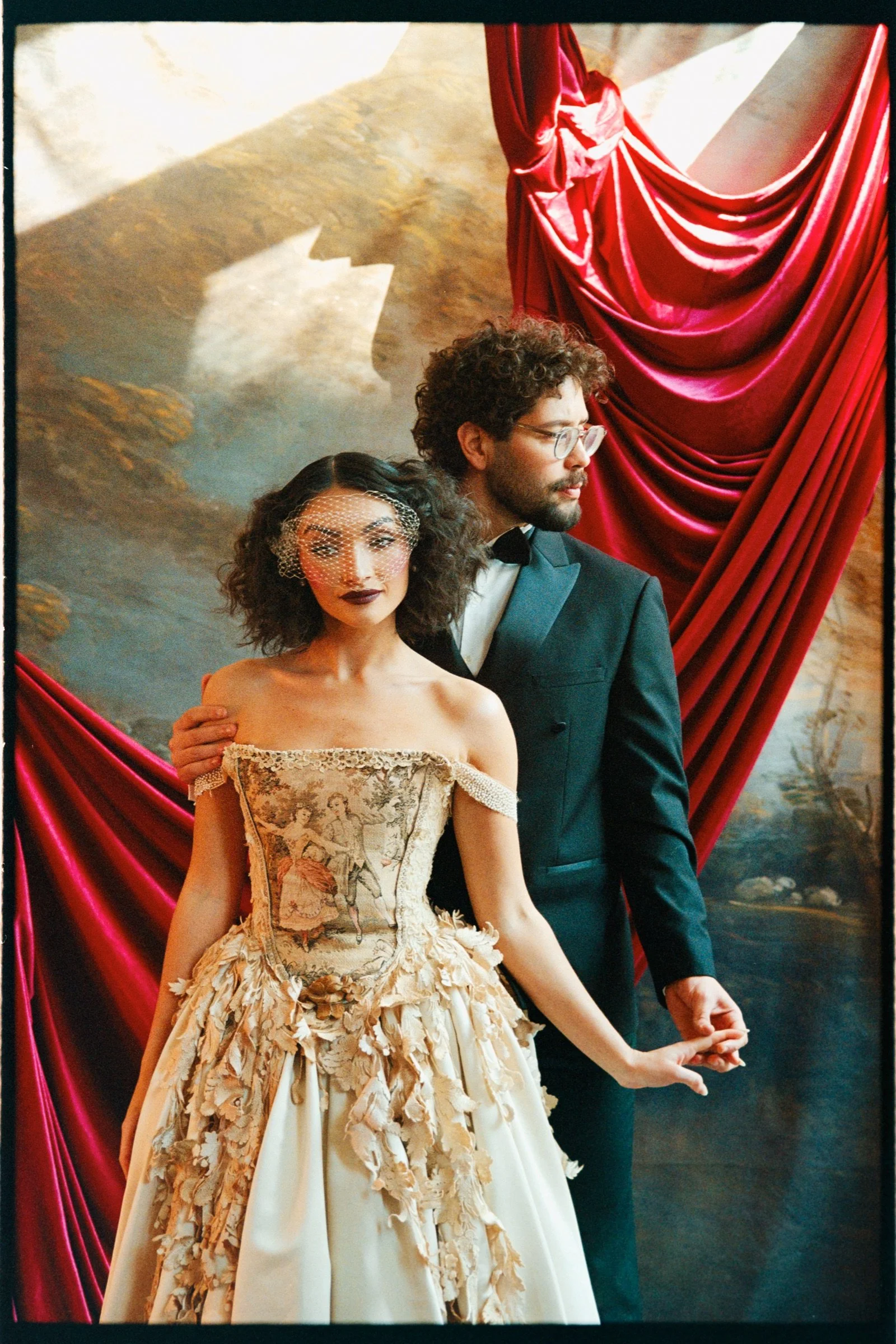 Two stage performers holding hands in the opera-inspired love story