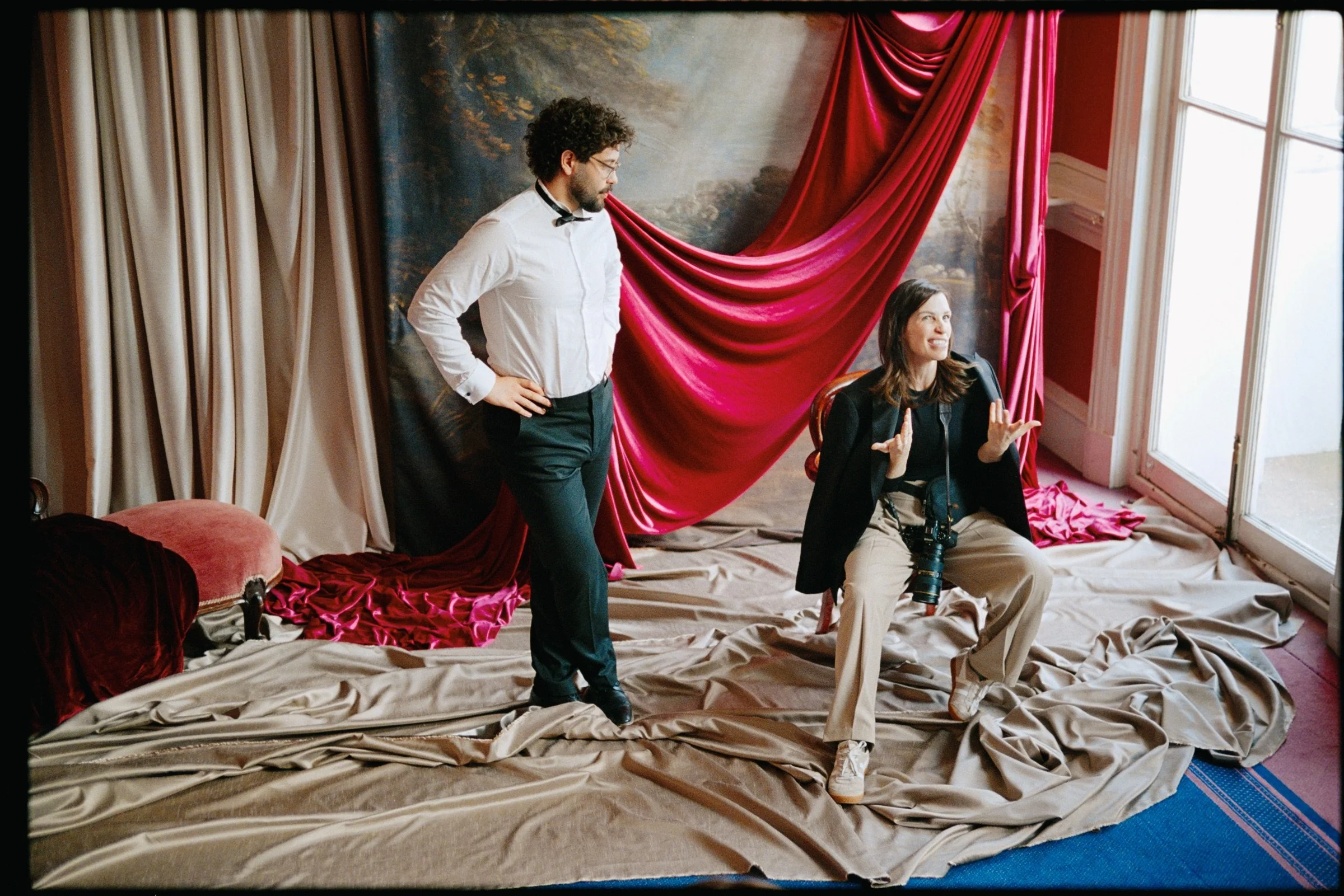 Behind-the-scenes moment with performers and creative team on the theatre set