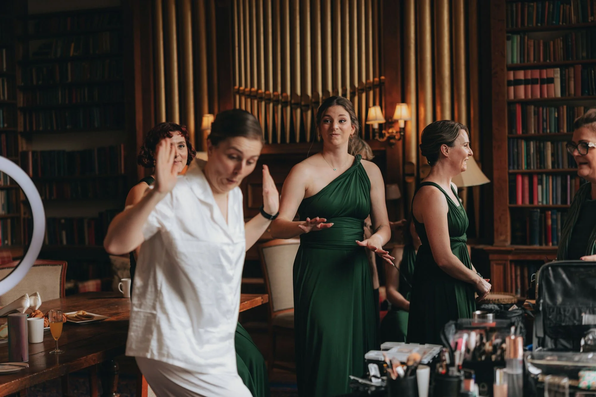 bridesmaid-helping-bride-get-ready-at-carberry-tower.jpg