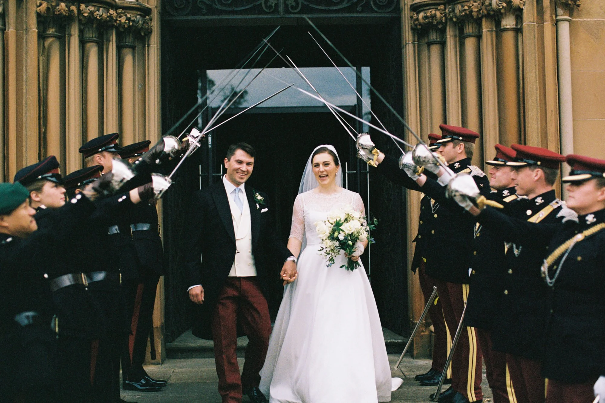 katy-and-will-walking-through-military-sword-arch.jpg