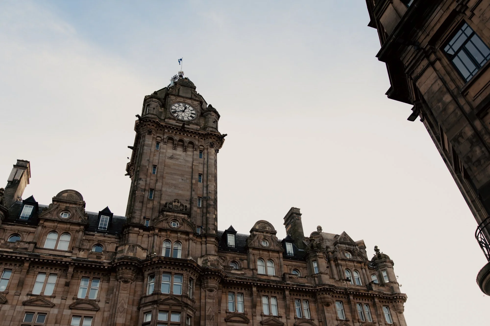 The Balmoral Hotel clock tower seen from an Edinburgh street.