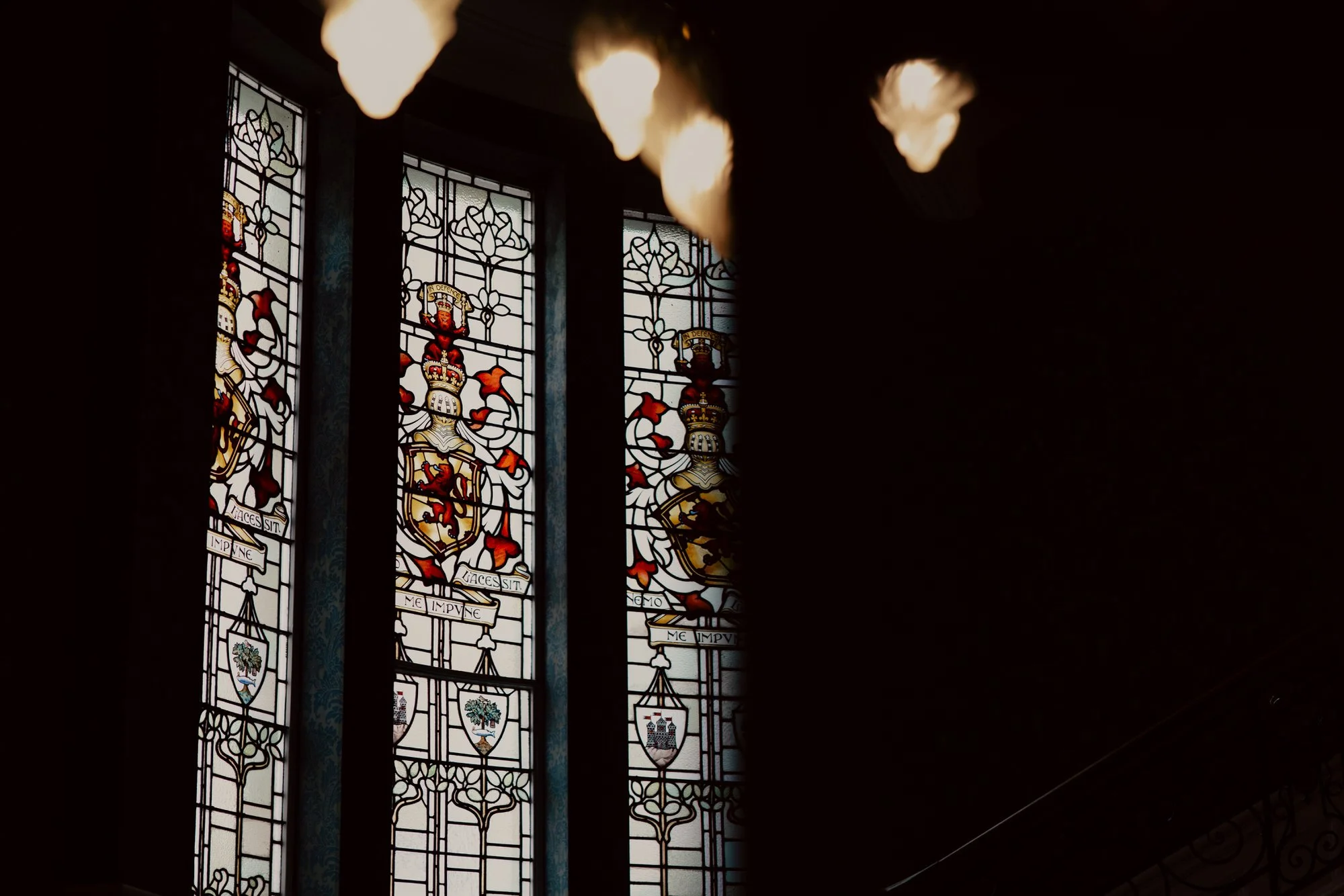 Stained-glass window and hanging lights inside the hotel.