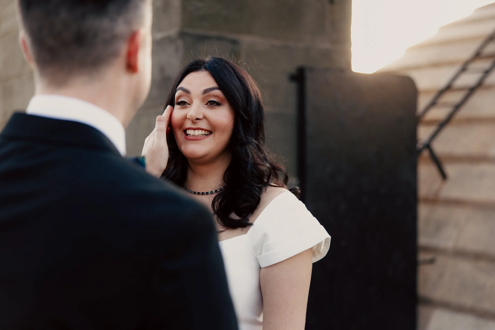 Milly smiling at Vincent during their rooftop photographs.